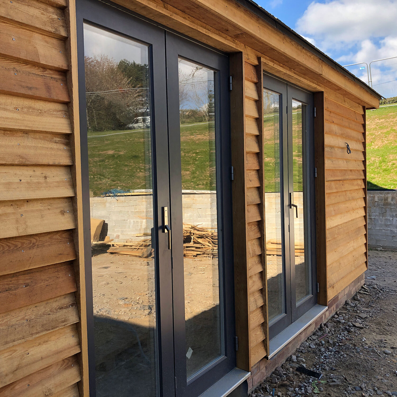 Glazed doors in contemporary Larch clad annexe