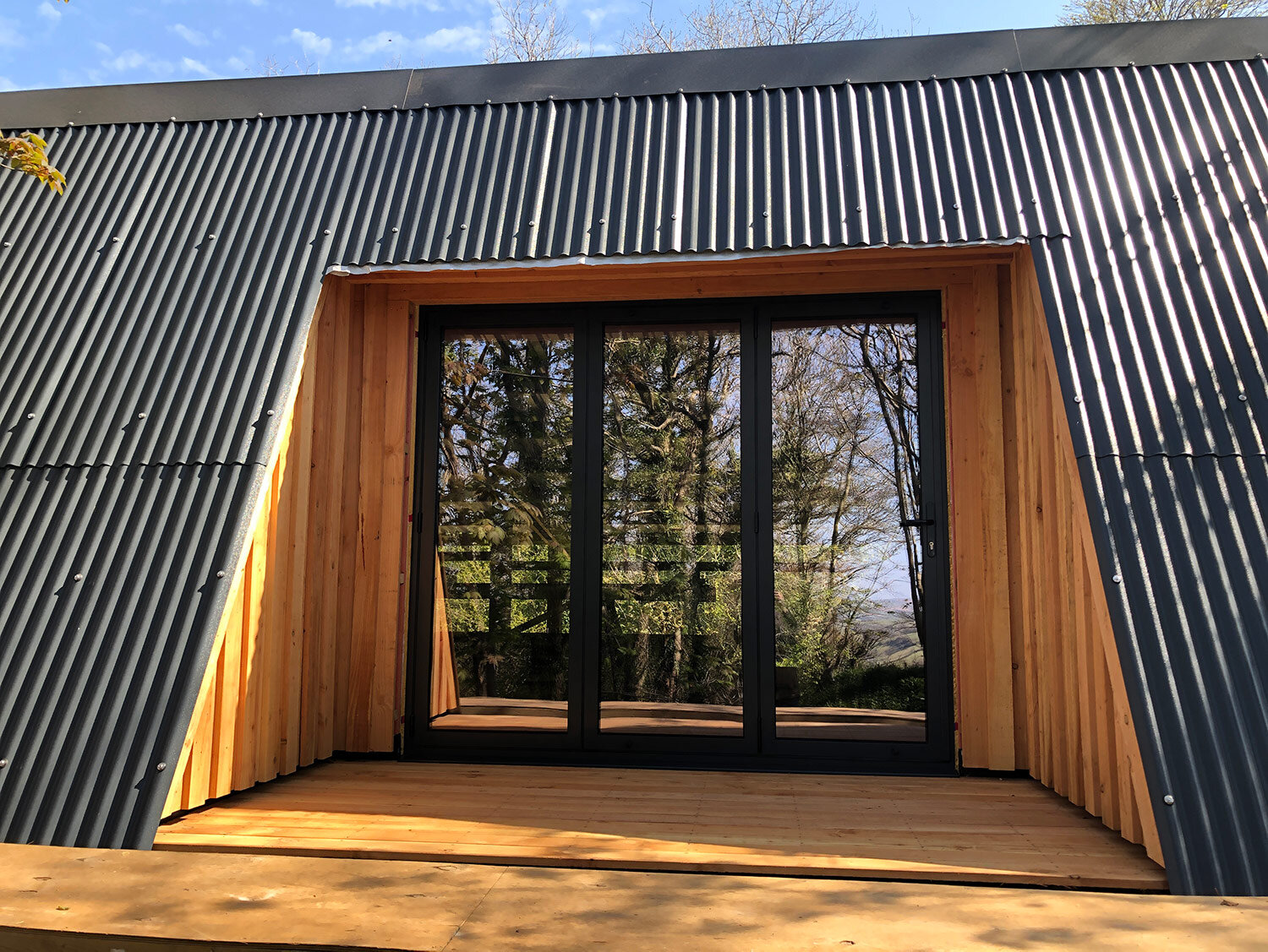 Bi-fold doors in off-grid cabin