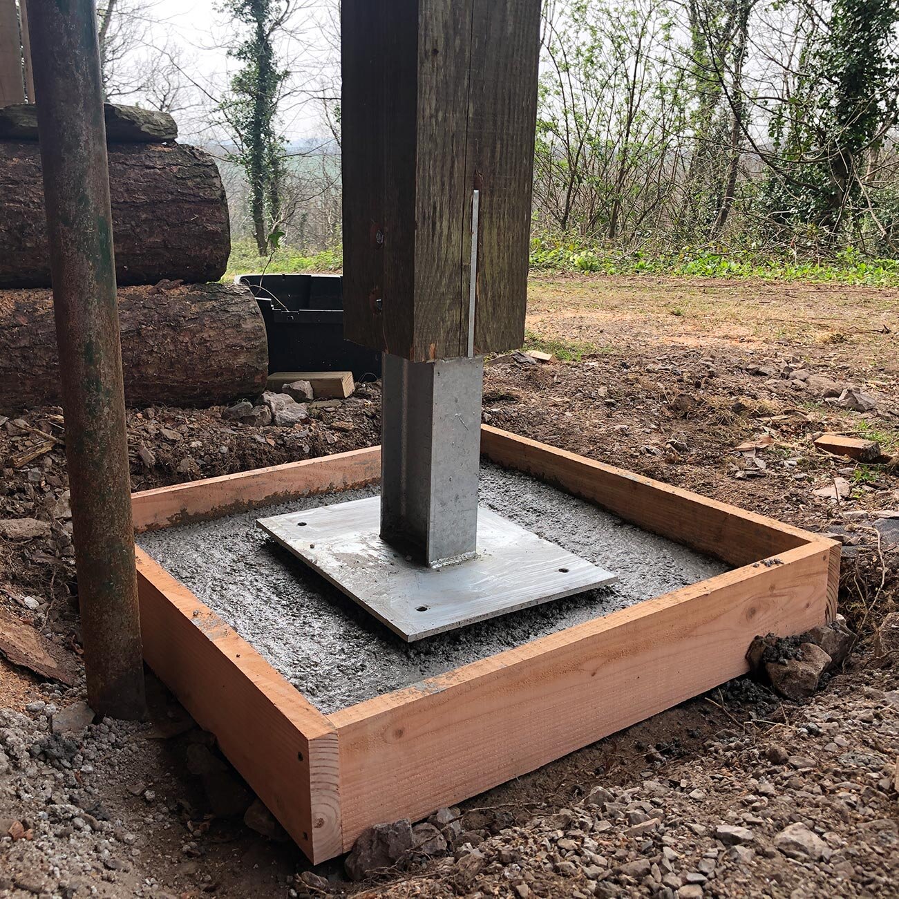 Engineered steel post foot fitted to cabin post