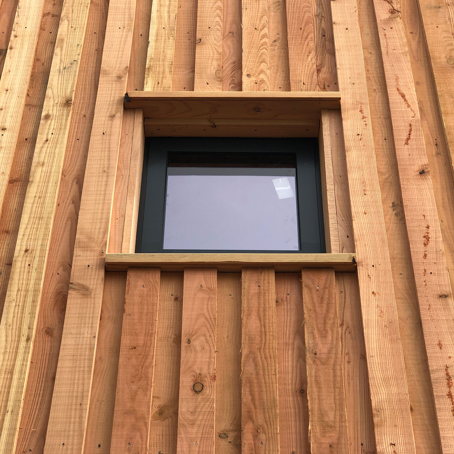 Detail of small window in timber cladding