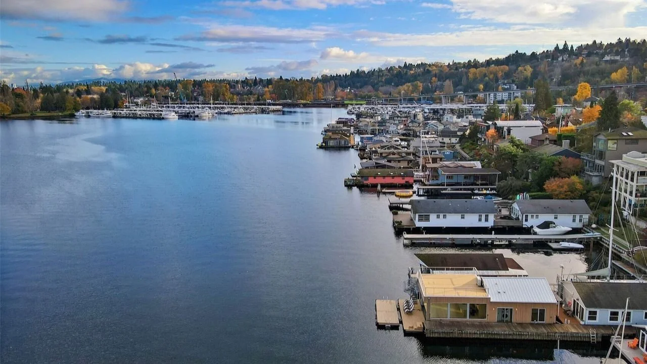 Aerial view showing Portage Bay and the surrounding floating home community near the Furhman Floating Home. The image provides context for the home’s waterfront setting and its connection to the broader Seattle shoreline.
