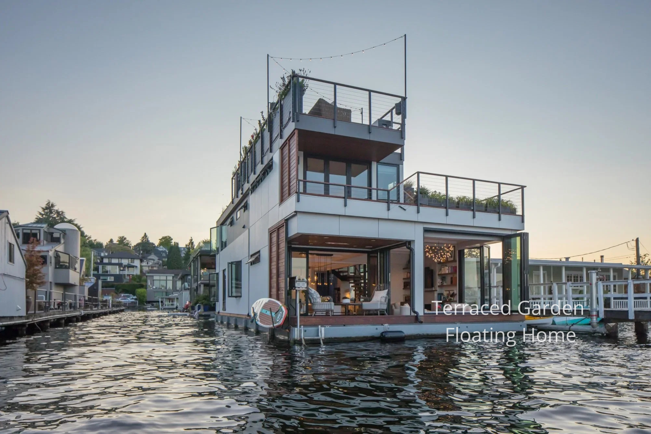 This Portage Bay Floating Home by ECCO Architecture is designed to fully embrace its waterfront setting. Positioned at the end of the community dock, the home enjoys unobstructed views and seamless indoor-outdoor living. Folding and sliding glass wal