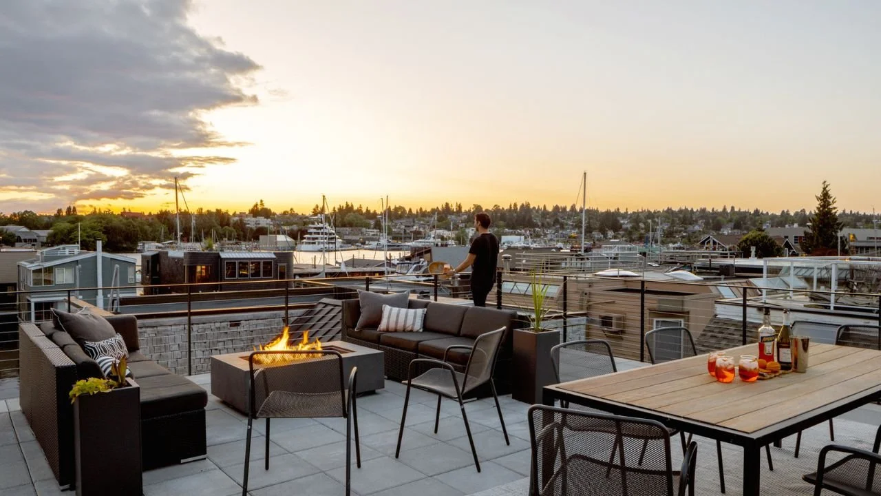 The Mallard Cove Remodel’s rooftop deck provides generous lounge and dining areas with expansive views across the marina and surrounding waterfront community. Comfortable seating and warm evening light create an inviting outdoor space for gathering a