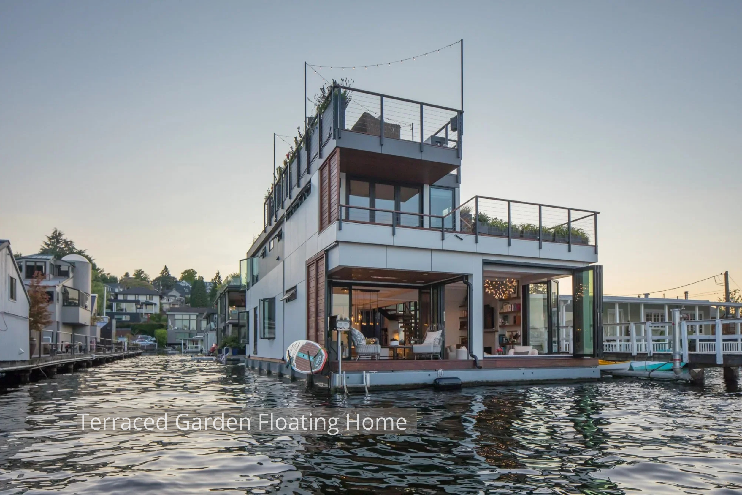 This Portage Bay Floating Home by ECCO Architecture is designed to fully embrace its waterfront setting. Positioned at the end of the community dock, the home enjoys unobstructed views and seamless indoor-outdoor living. Folding and sliding glass wal