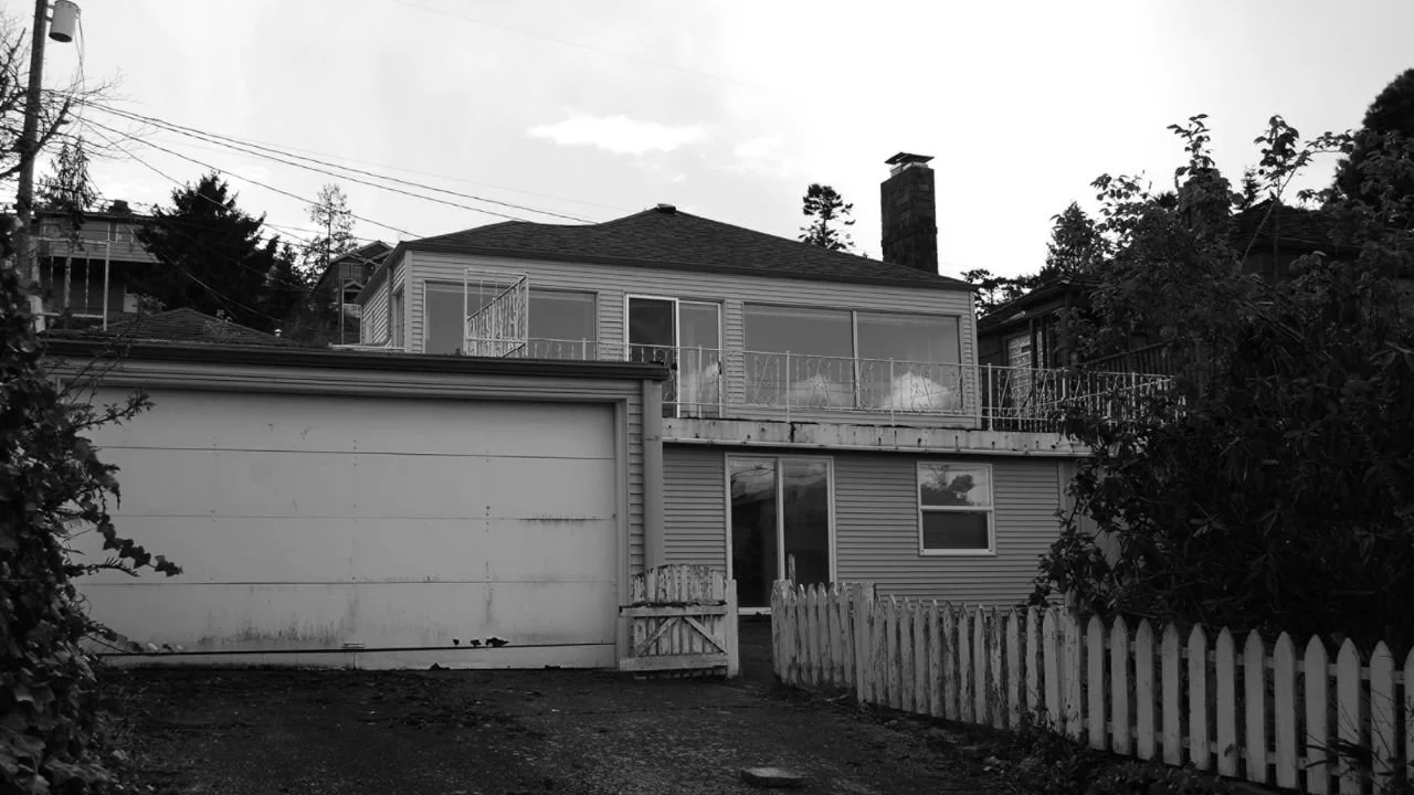 Black-and-white image of the original one-story Land’s End home before its extensive renovation and vertical expansion. The existing residence provided the foundation for a larger, light-filled home designed to improve function, square footage, and w