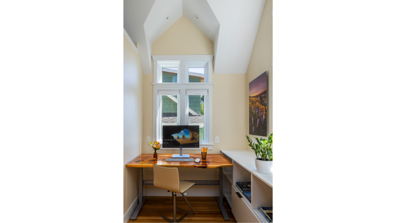 Built-in office nook within a Seattle DADU, featuring a compact workspace, integrated desk, and natural light from upper-level windows. The vaulted ceiling enhances vertical space, creating an open and functional work area within a small footprint. T