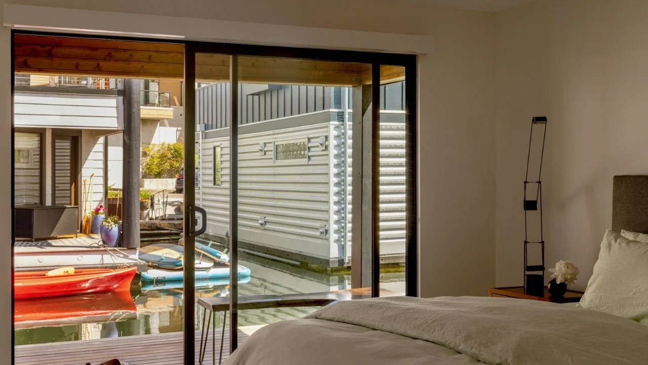 mallard-cove-remodel-bedroom-sliding-glass-doors-dock-view.jpg.jpg