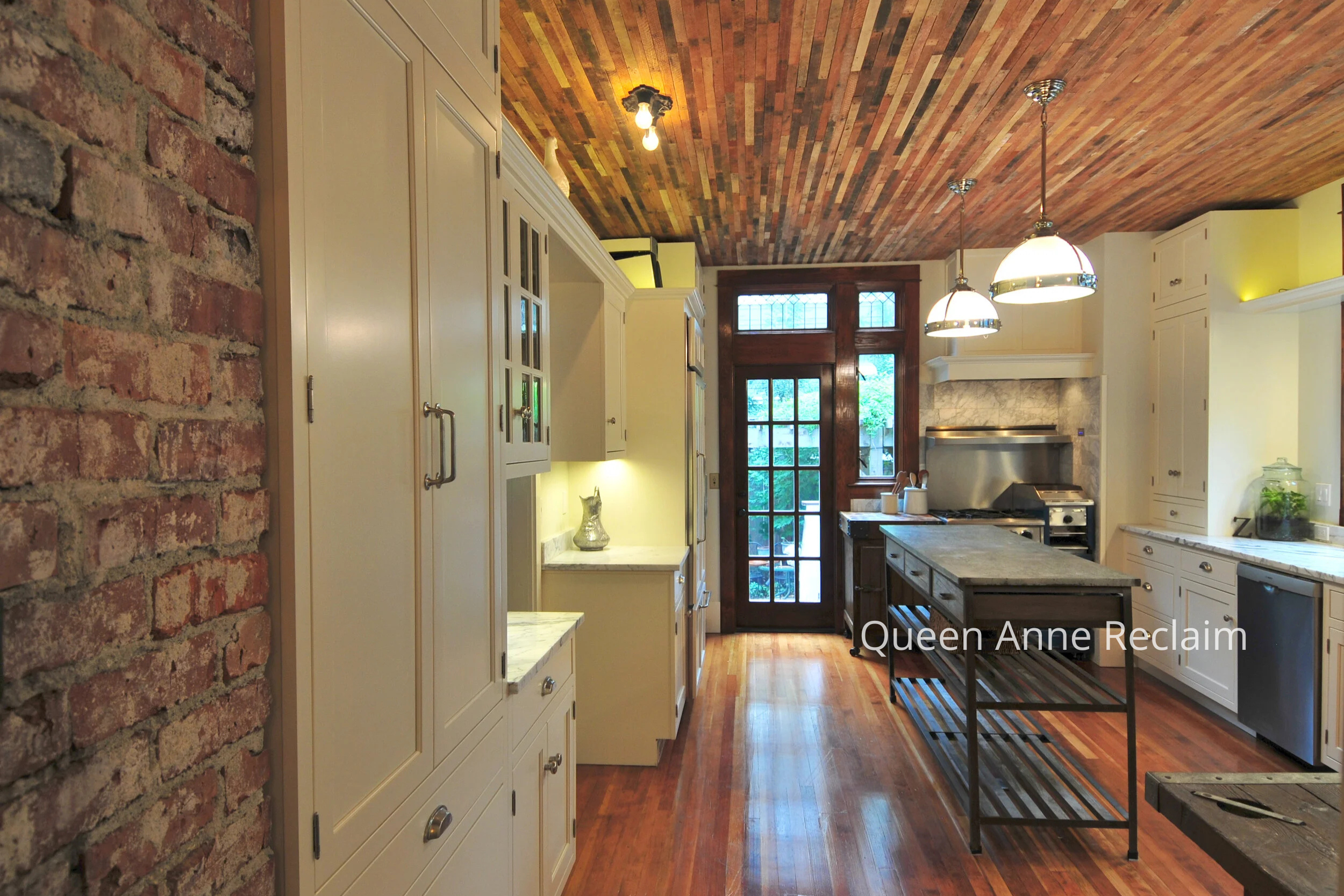 The Queen Anne Kitchen Reclaim Remodel by ECCO Architecture transforms a cramped, dated space into a warm, inviting culinary haven. By expanding the footprint and introducing a generous U-shaped layout, the design supports both everyday cooking and e