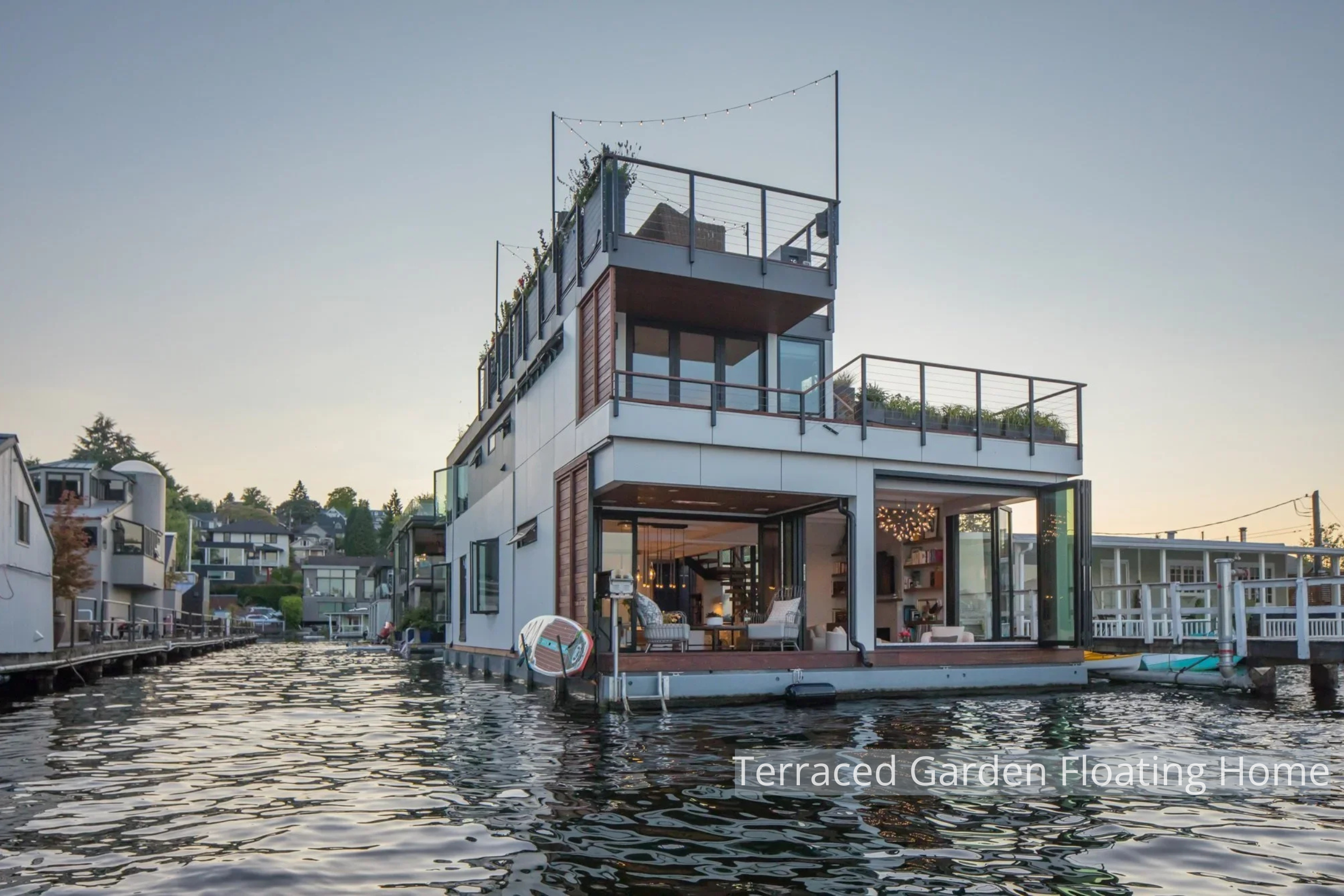 This Portage Bay Floating Home by ECCO Architecture is designed to fully embrace its waterfront setting. Positioned at the end of the community dock, the home enjoys unobstructed views and seamless indoor-outdoor living. Folding and sliding glass wal