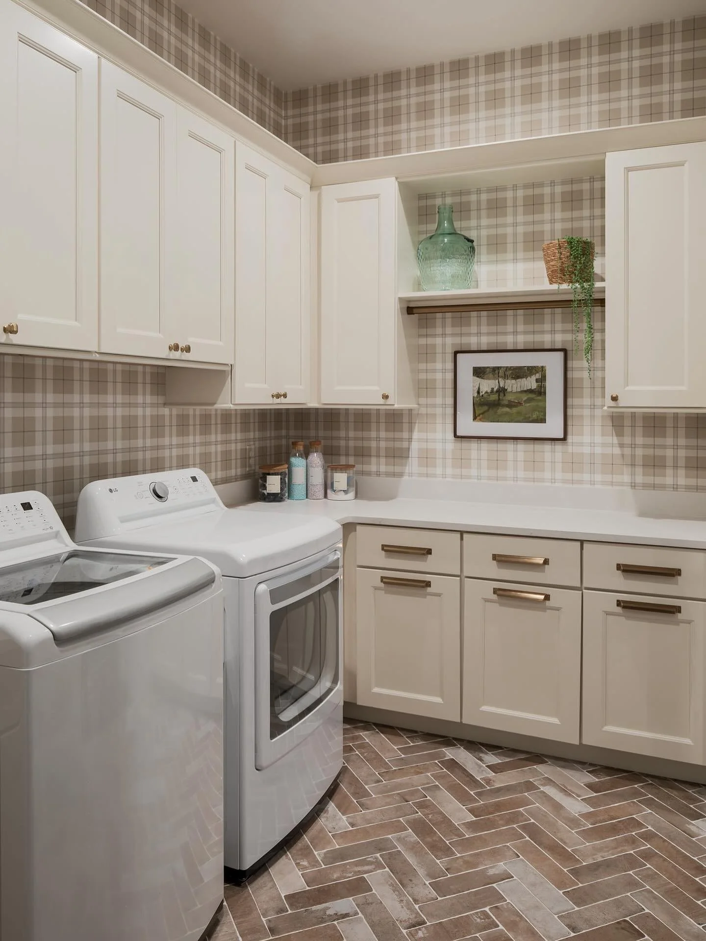 The prettiest laundry room that also offers tons of storage and functionality!! 
.
.
.
#cincinnaticustomcabinetry #laundryroomdesign #functionality #brickfloors #wallpaper