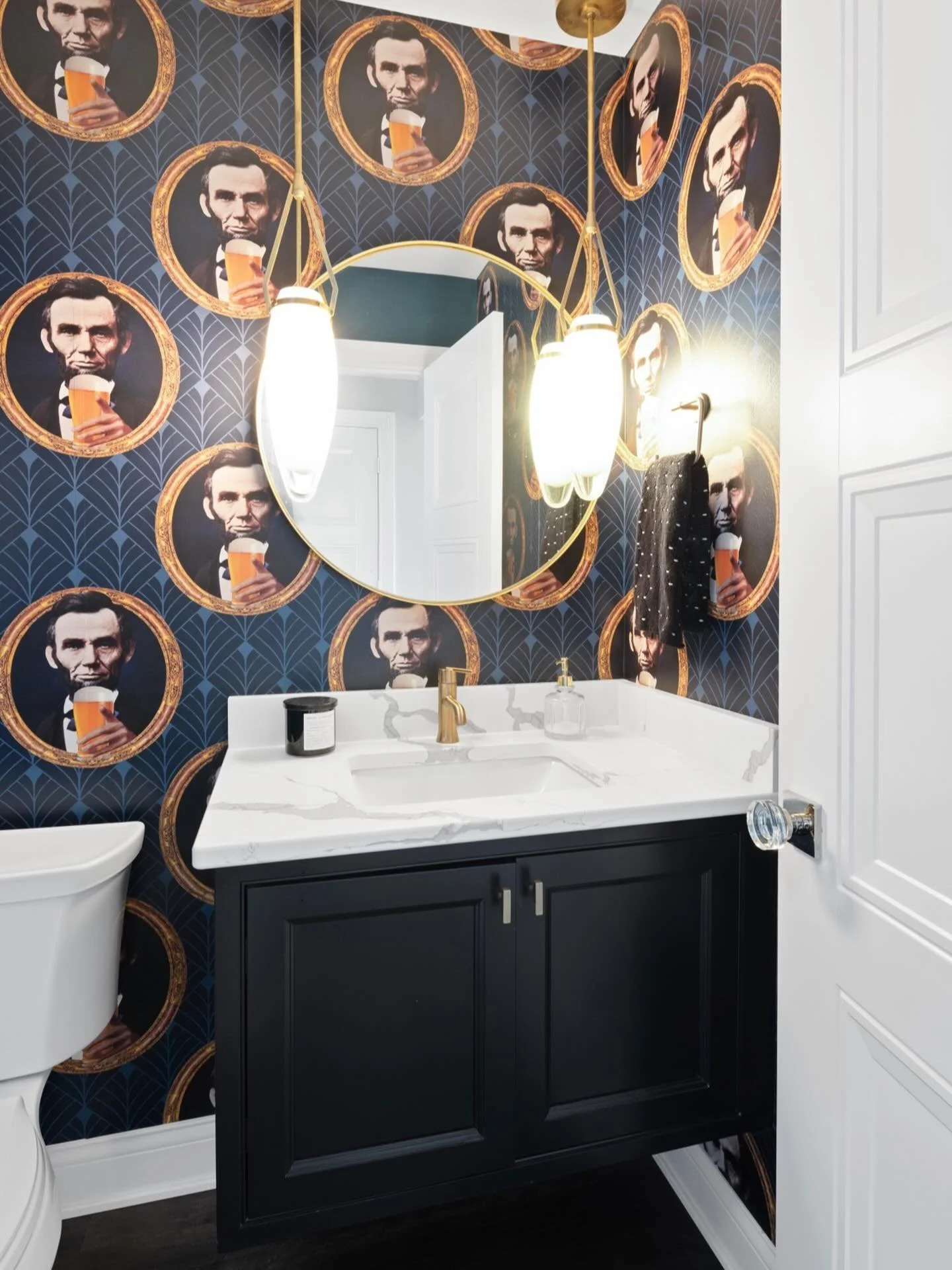 Who doesn&rsquo;t love a playful powder room? This one is perfect off a rec room bar, continuing the vibes in here with this moody floating cabinet and fun wallpaper! 
.
Photo by @grupenhof_photo 
.
.
.
#cincinnaticustomcabinetry #cabinetdesign #powd