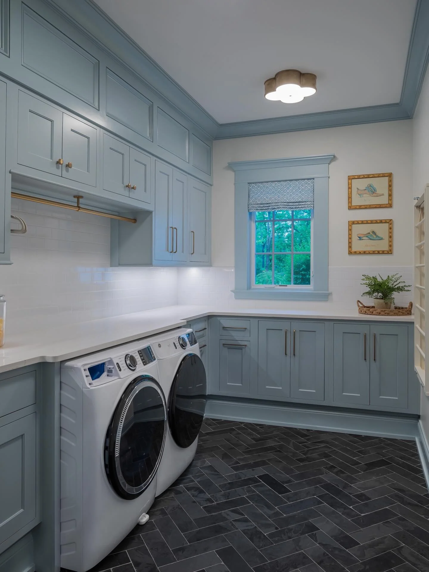 Soft blue cabinetry, brass accents, and smart storage&mdash;proof that a laundry room can be just as beautiful as it is hardworking. 🧺✨ Designed to keep everything in its place while elevating the everyday.
.
Photo by @kristen_g_photography 
.
.
.
#