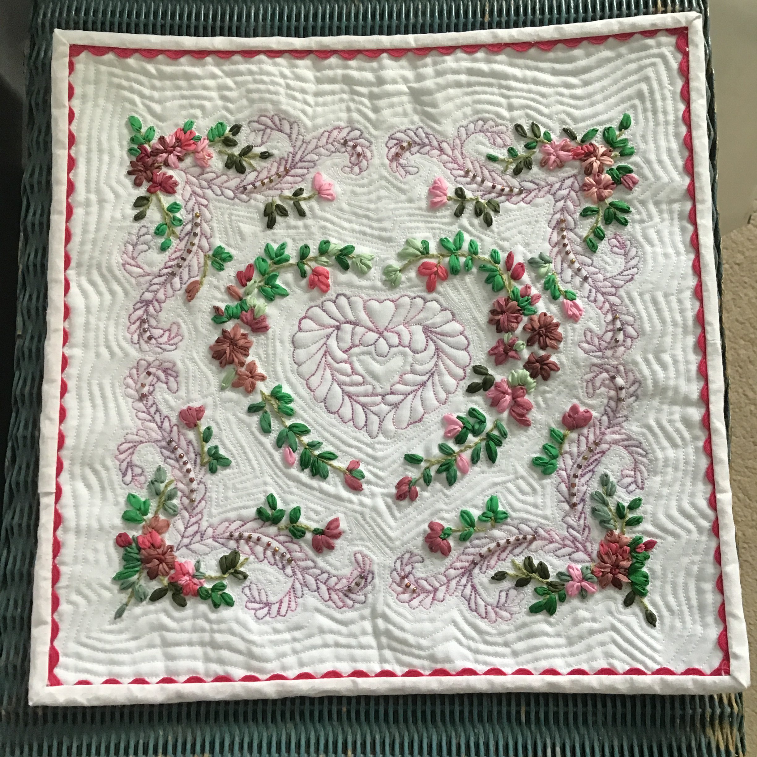 Sue's miniature quilt, after Kumiko Frydl miniature quilt, 11" square. Ribbon embroidery and beading. Feathers quilted one stitch at a time.