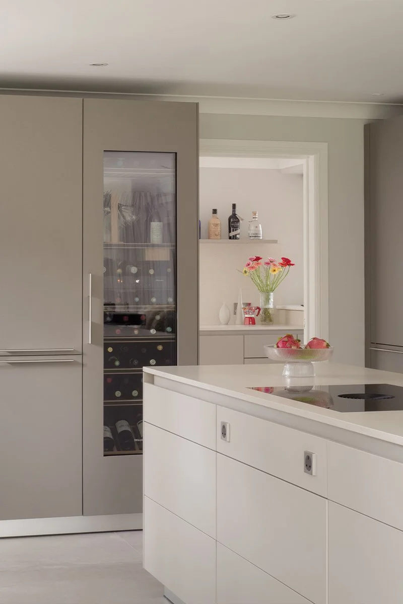 Contemporary Bulthaup kitchen flowing into adjoining utility room with cohesive design