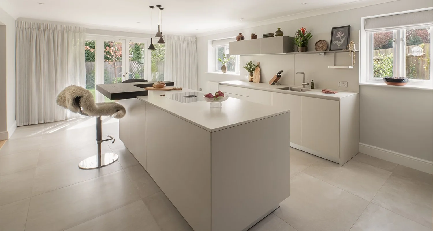 Modern Bulthaup kitchen with flint finish and island, opening onto garden with large windows