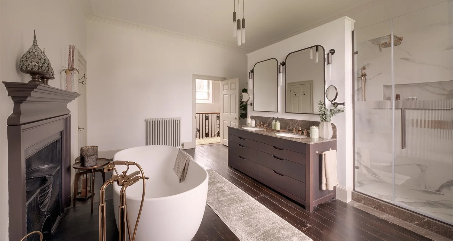 Georgian manor master ensuite with warm tones, open layout, and a blend of traditional and contemporary design and free standing bathtub..