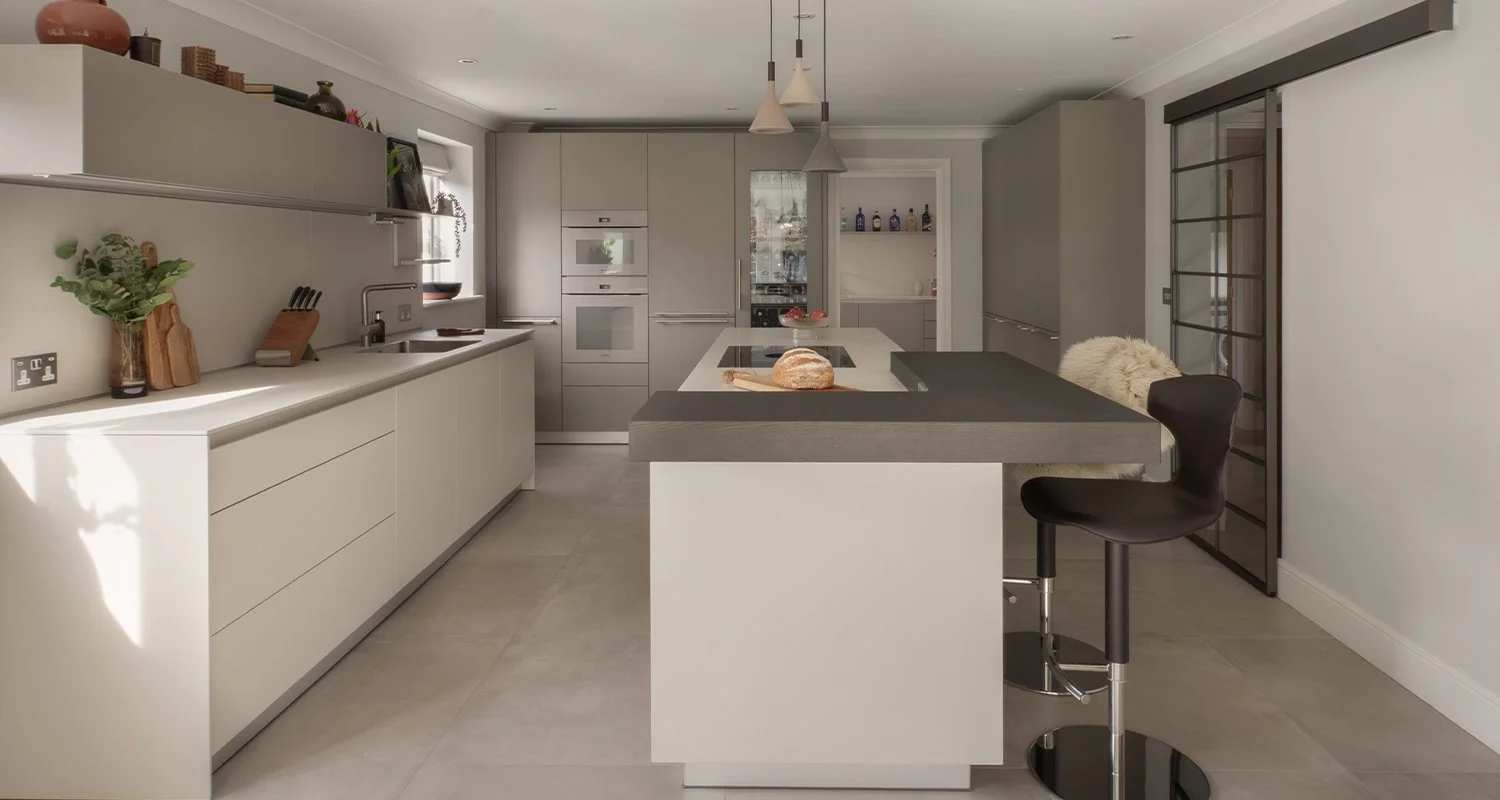Handleless Bulthaup kitchen units with open shelving and neutral flint finish
