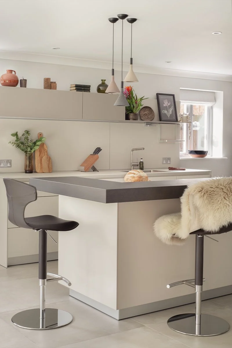 Minimalist kitchen island with breakfast bar seating in modern Bulthaup kitchen
