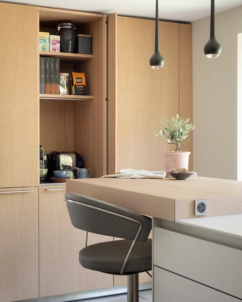 bulthaup breakfast bar with light oak cabinetry and pendant lighting