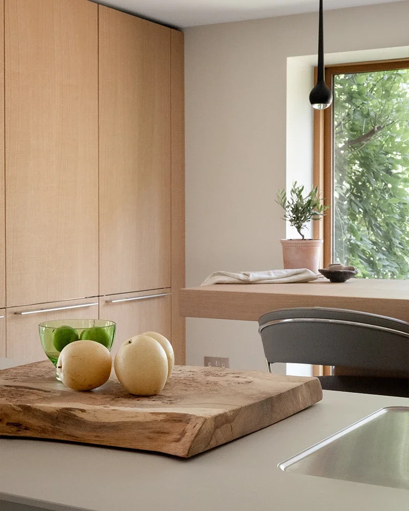 Light oak bulthaup cabinetry with kitchen island and breakfast bar