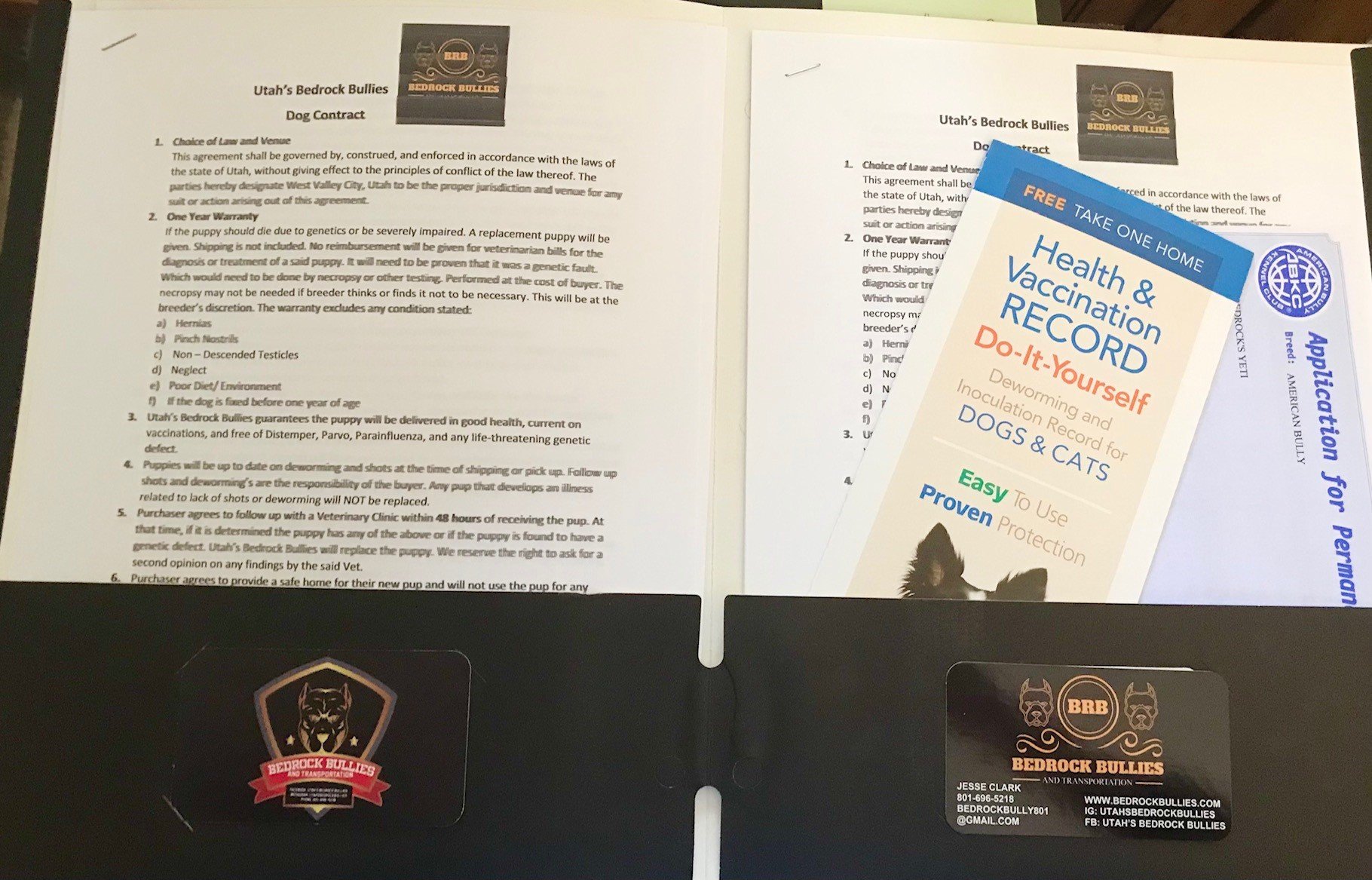 Inside the folders: Copy of Dog Contract, Vaccination Records, ABKC Registration papers, business card.