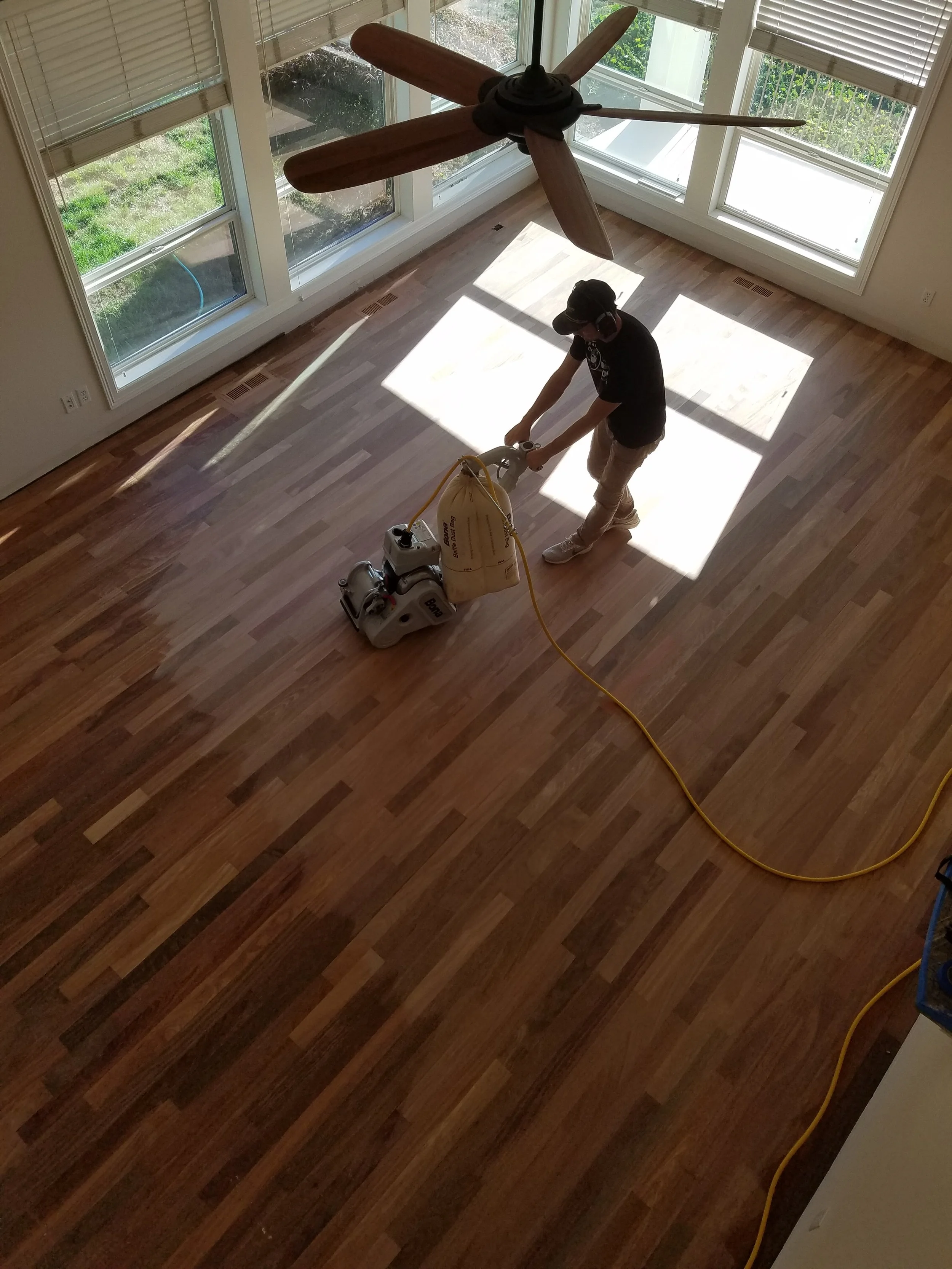 Sanding and refinishing a hardwood floor restoration project in Boise Idaho