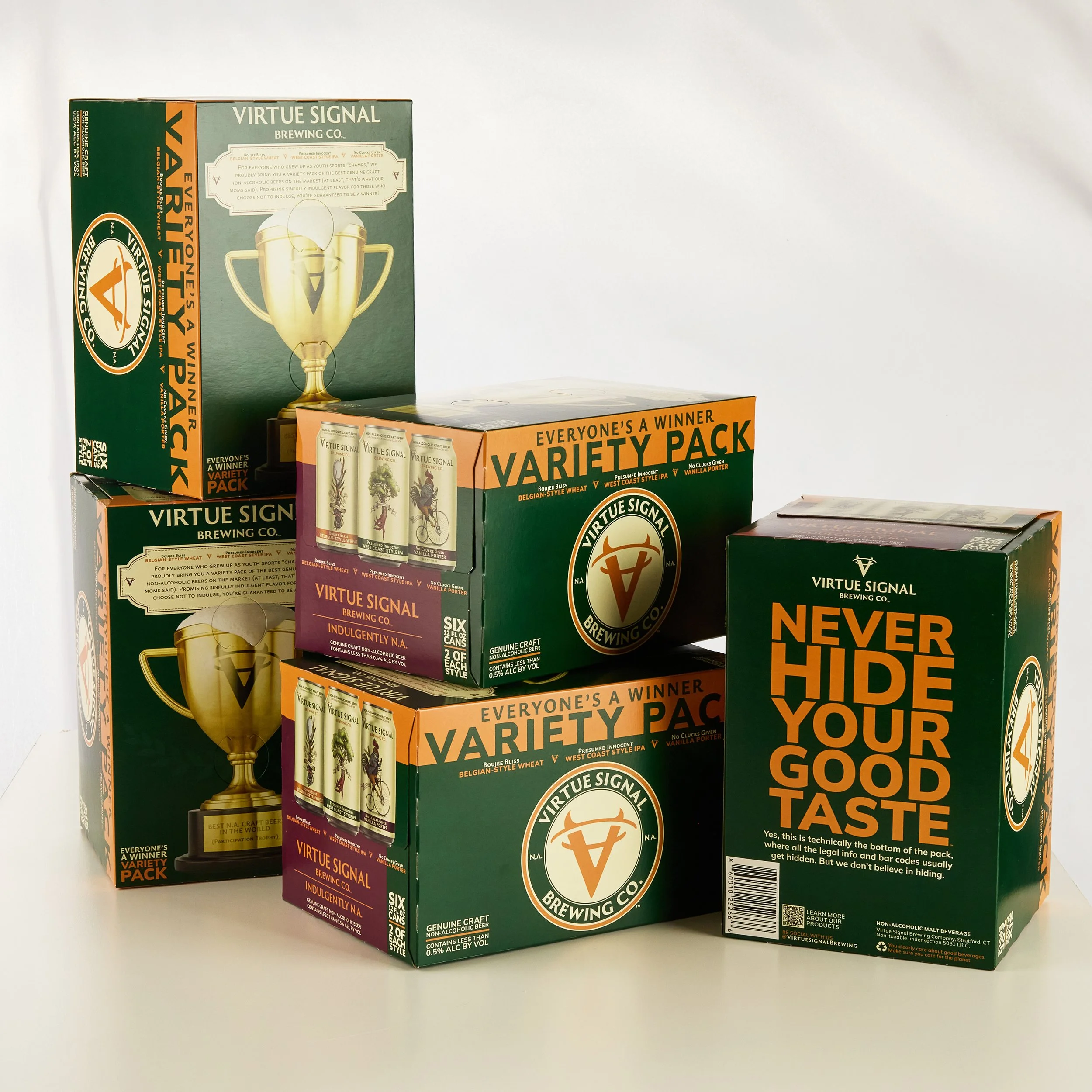 Boxes of Virtue Signal Brewing Co. non-alcoholic beverage variety pack, featuring a gold trophy image and text on green, orange, and purple packaging.
