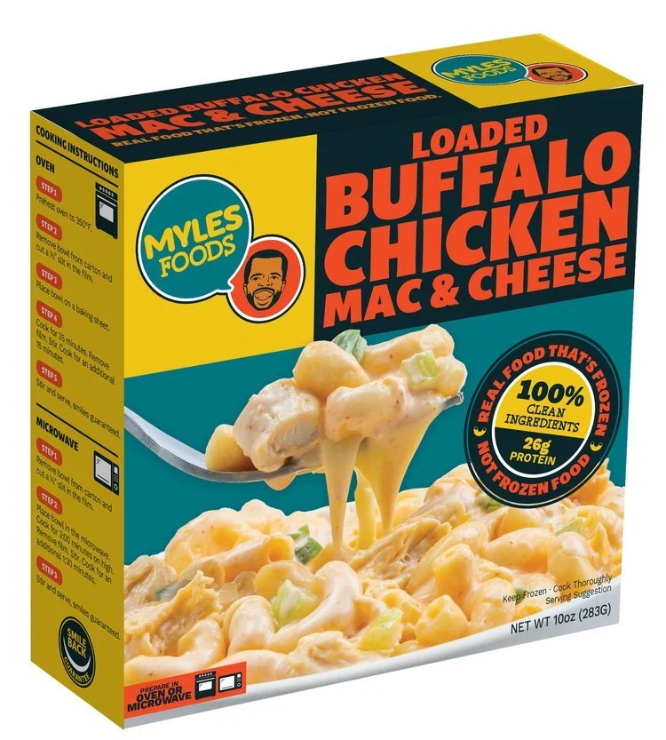 Packaging of Myles Foods Loaded Buffalo Chicken Mac & Cheese, featuring the product name, an illustration of a person, and a photo of the dish on a fork, along with cooking instructions and nutrition information on the sides.