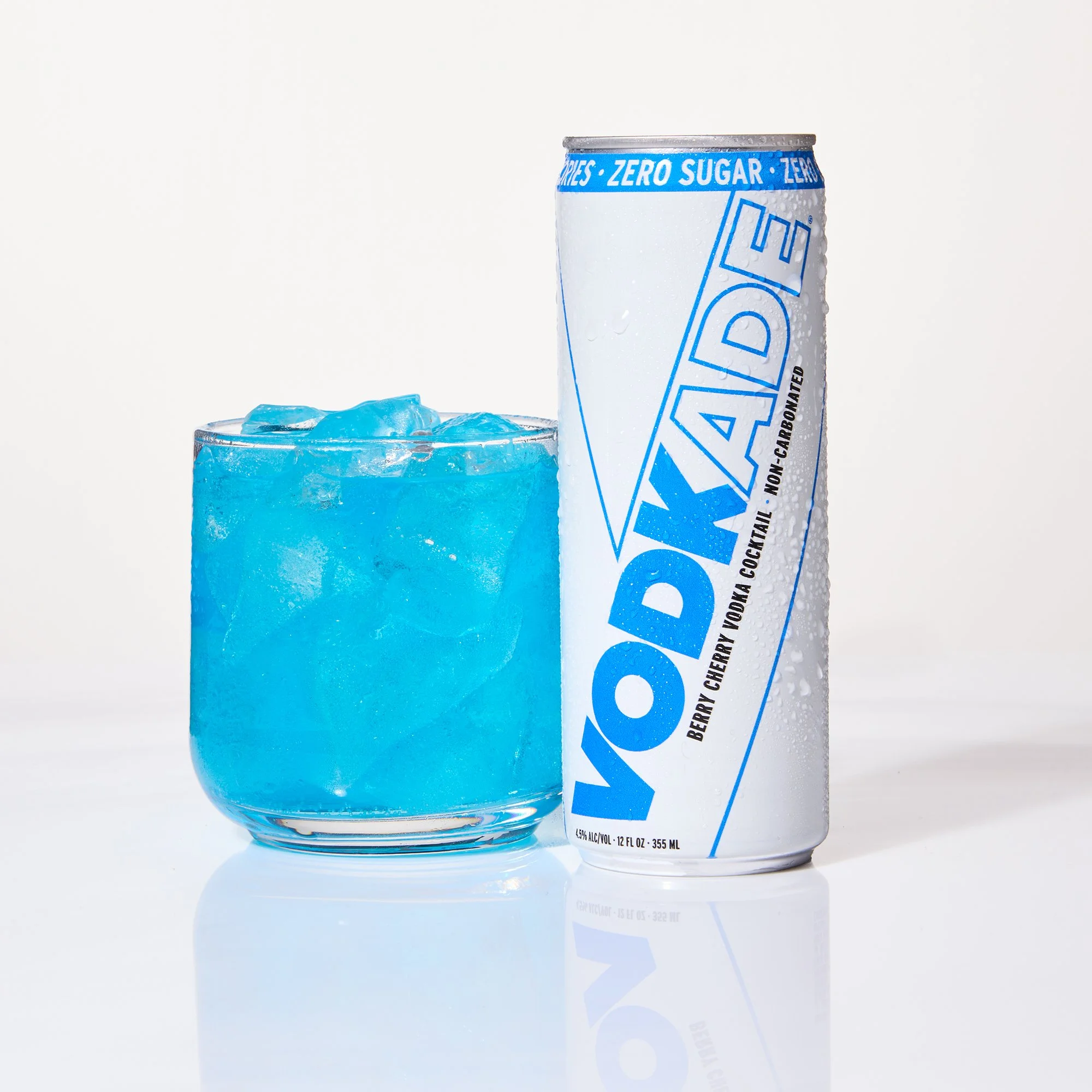 Close-up of a can of Vodkade zero sugar berry cherry flavored malt beverage and a glass filled with blue ice