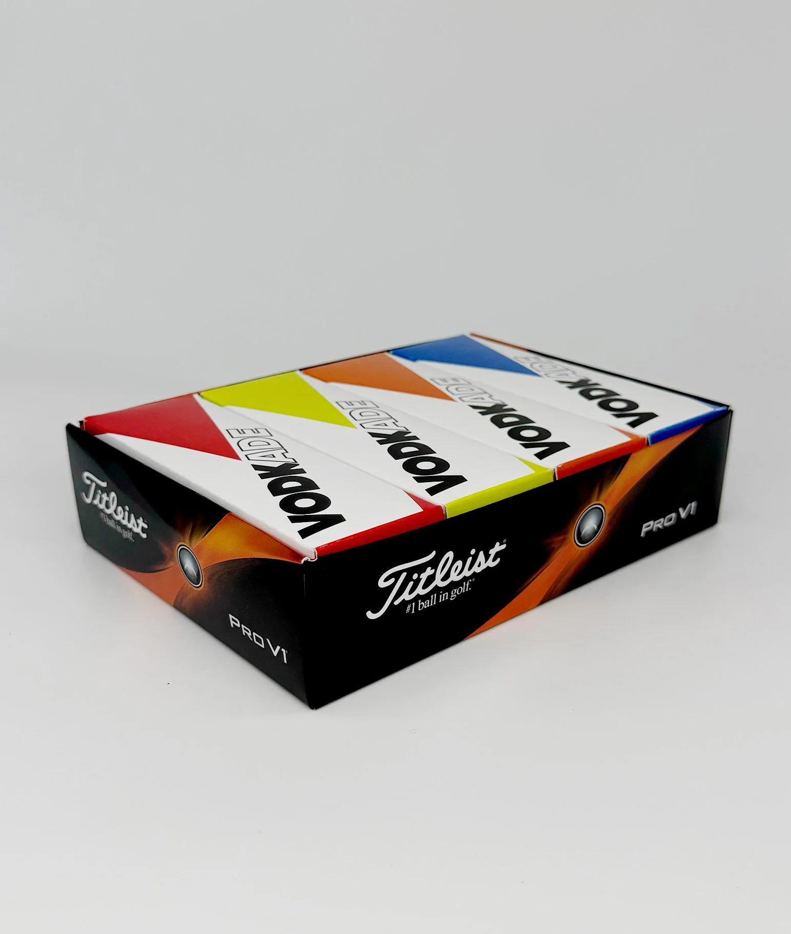 Box of Vodkade-branded Titleist Noptimade Pro V1 golf balls with colorful design and branding.