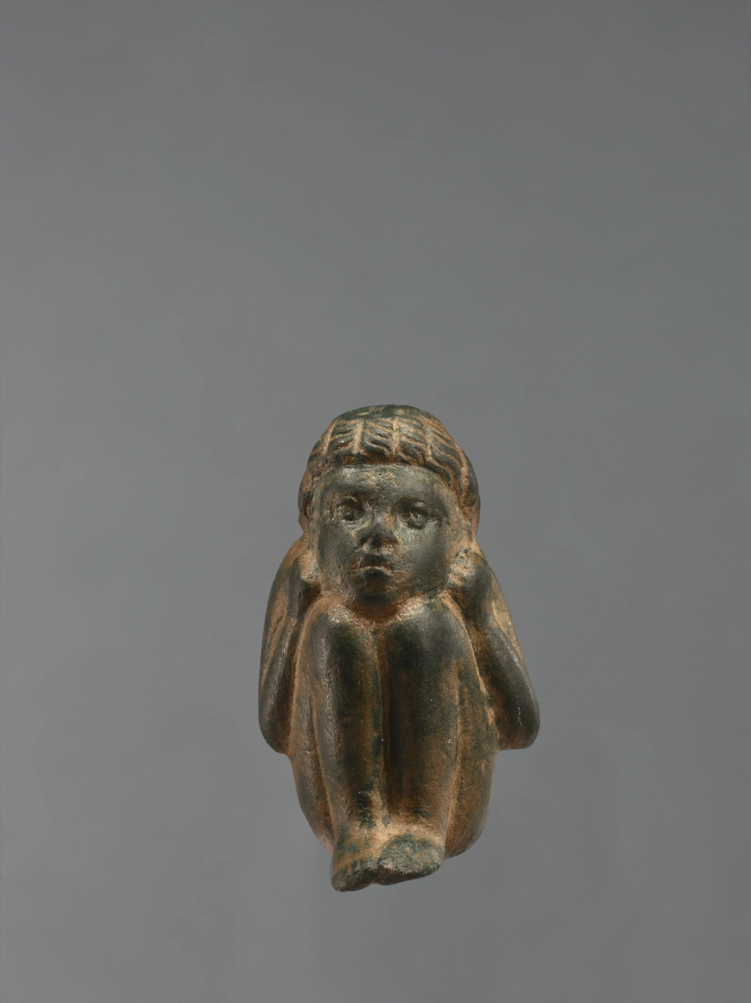 Ancient Hellenistic Greek Bronze Figurine in the shape of a Young Crouching African