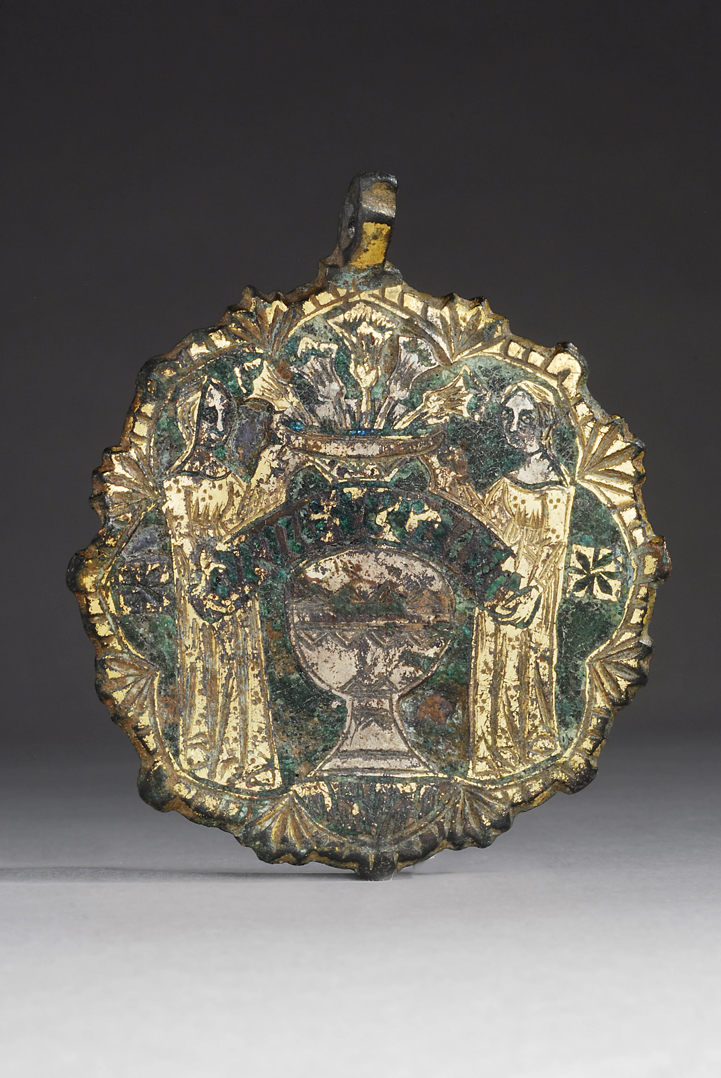 Medieval Bronze Circular Pendant with Two Saints Surrounding a Vase with Flowers