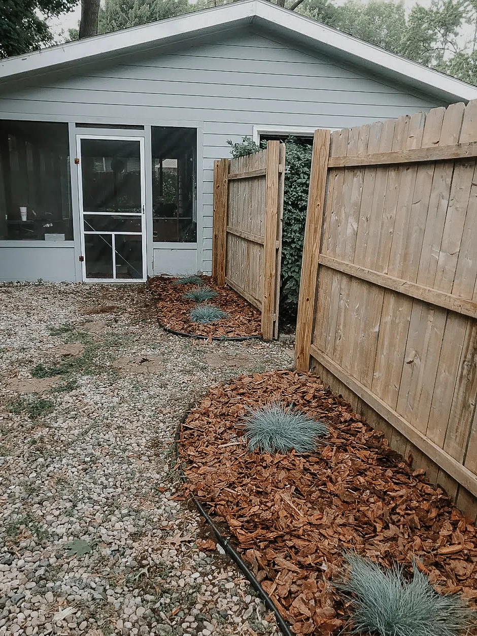 One of the areas in our backyard where we power washed the fence, put down fresh mulch &amp; perennials of the fescue variety.