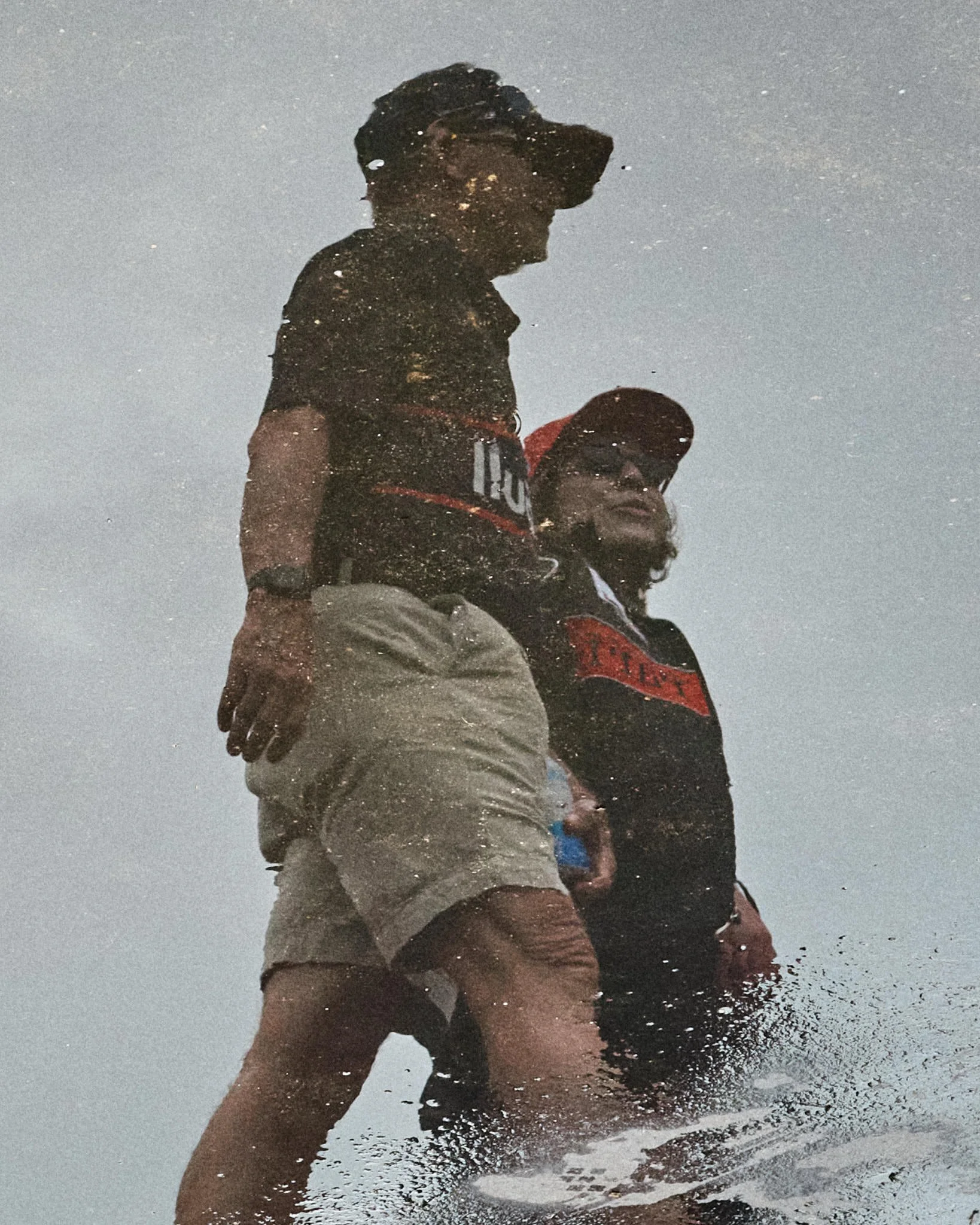 Mattellis-Two-People-Puddle-Reflection.jpg