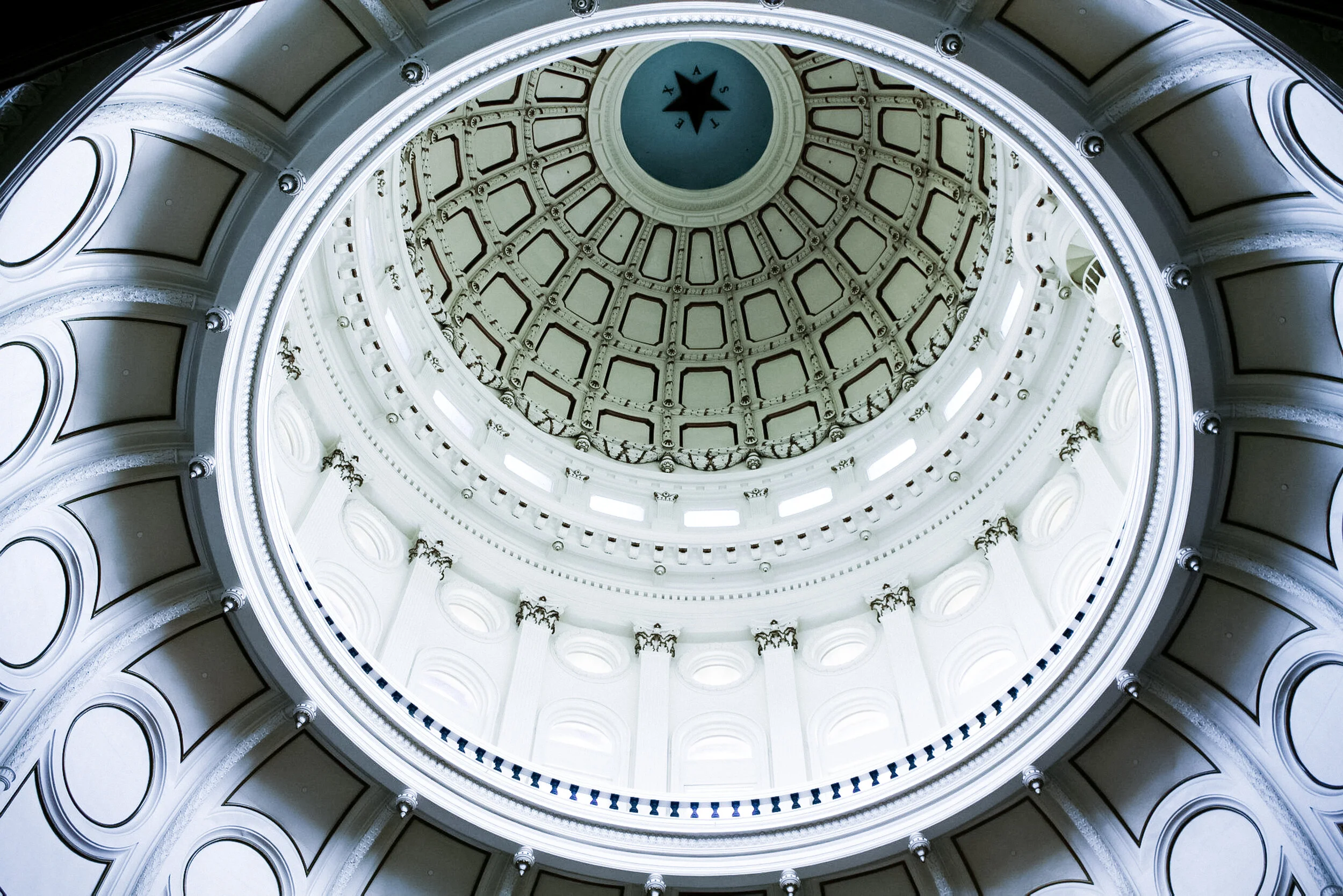 View of the interior dome ceiling of a government building or capitol, featuring decorative elements and a star symbol with letters 'A S A' at the top center of the dome.