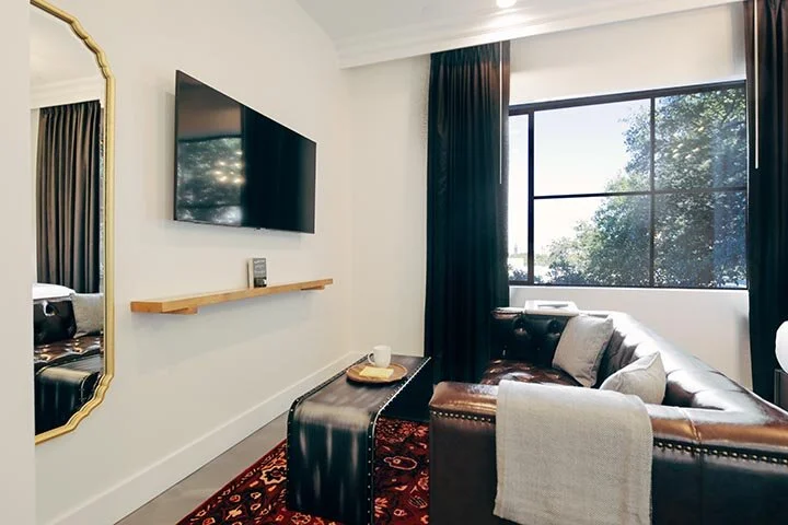 leather couch, coffee table, tv in living area