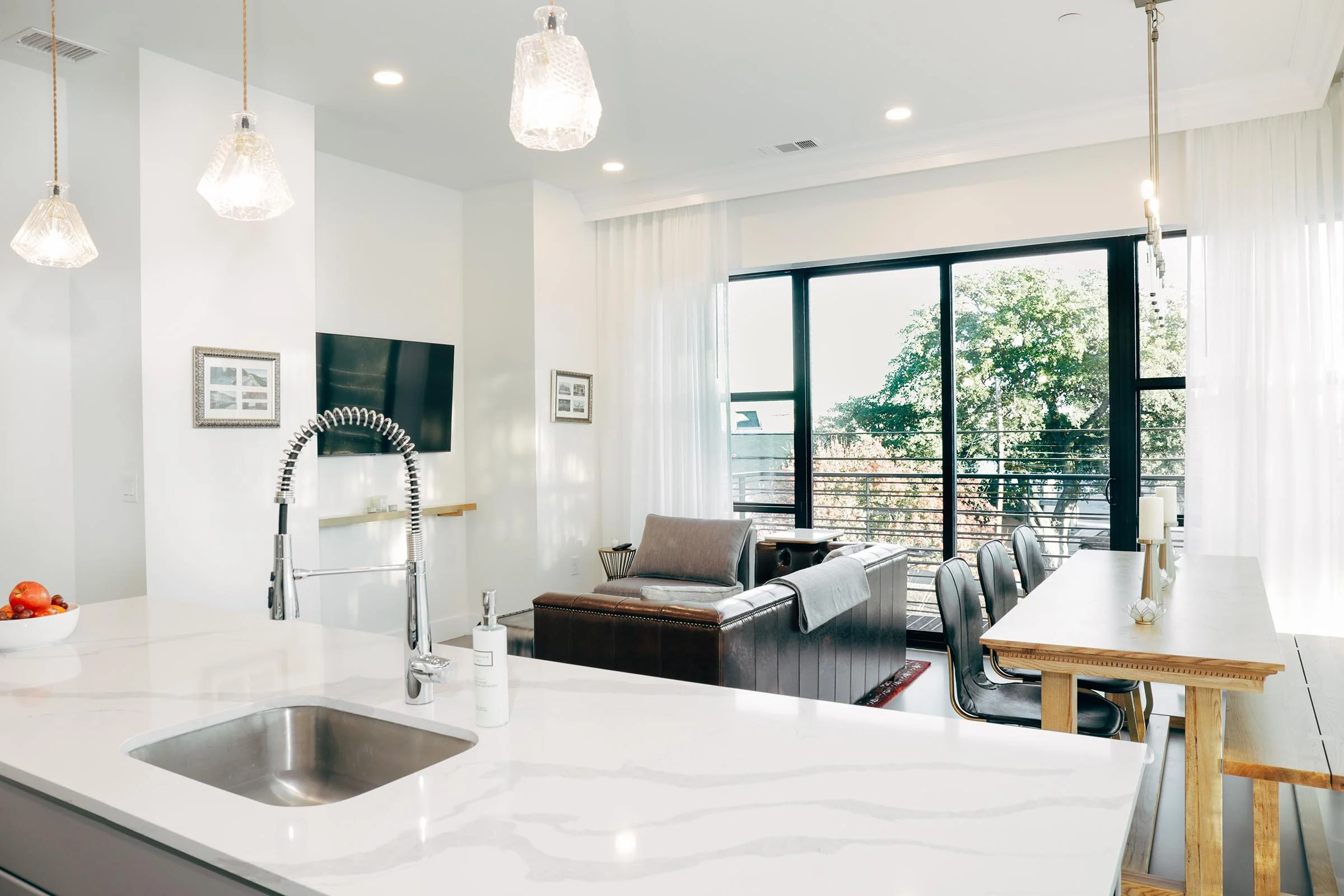 kitchen counter, dining table, and living area with couch  (Copy)