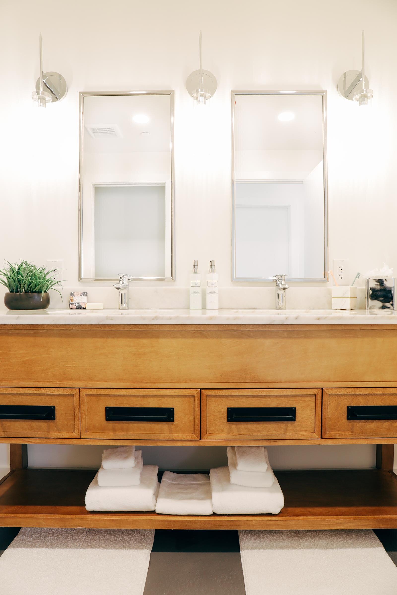 double sink vanity with wooden drawers and white countertop