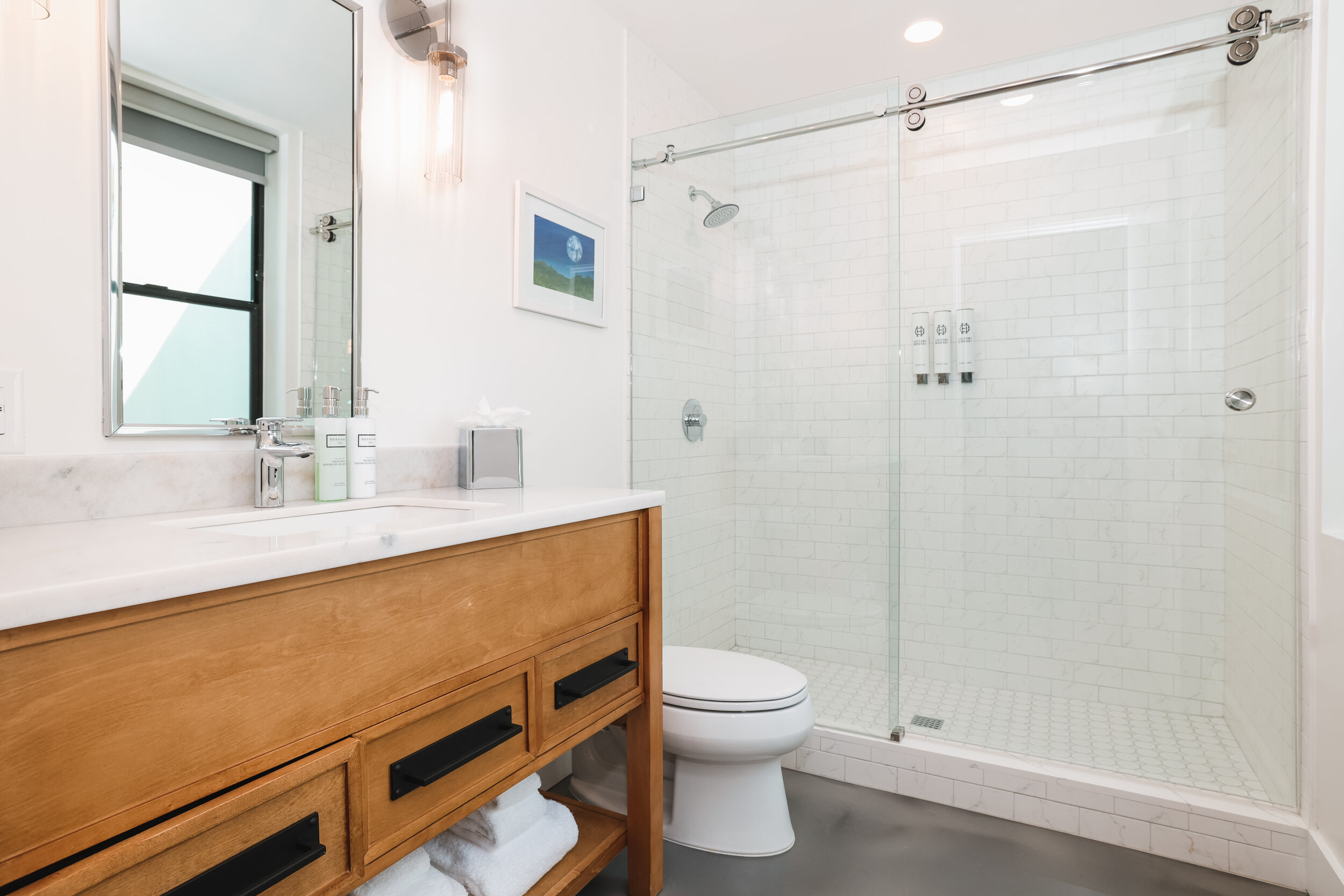 walk-in shower, wooden vanity with white countertop, toilet 