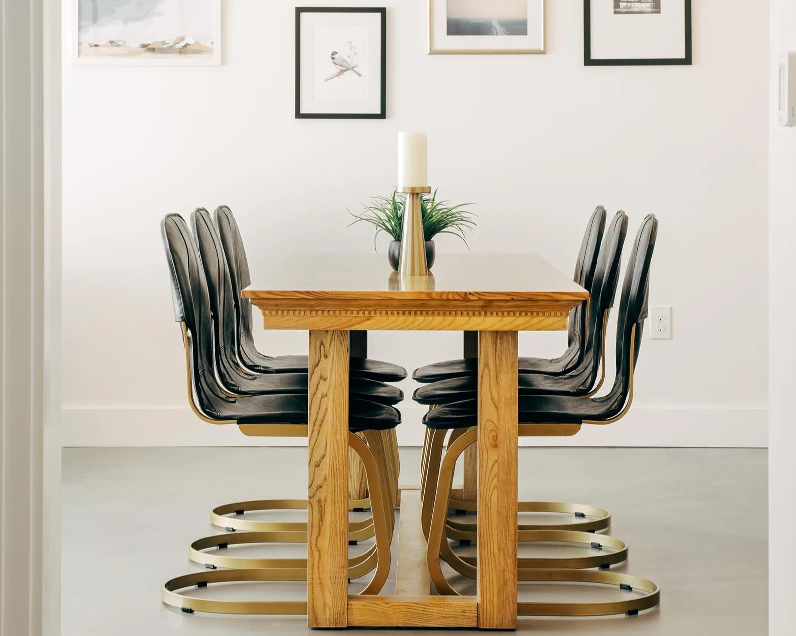 wooden dining table with three chairs on either side