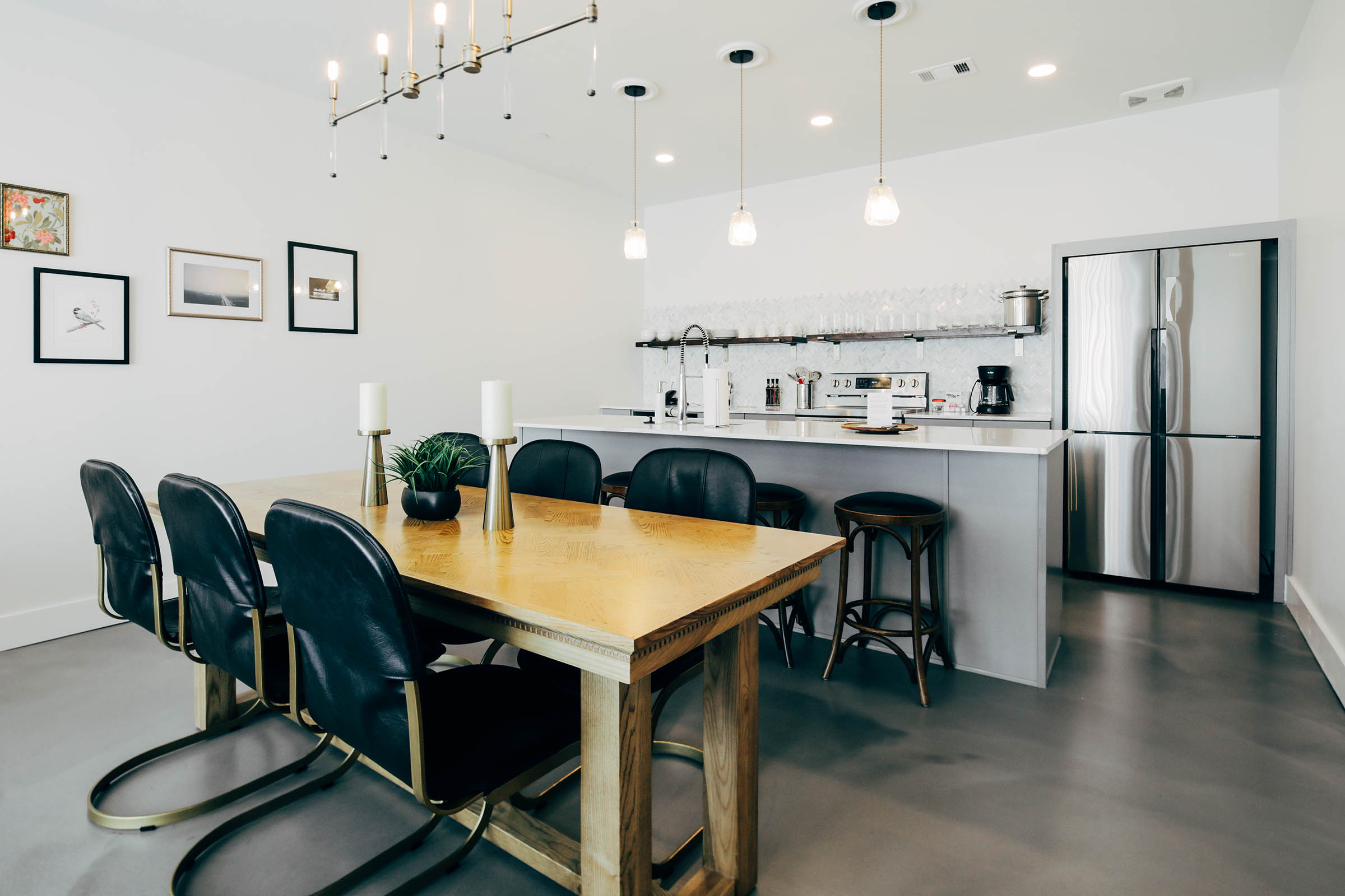 gray chairs, leather couch, dining table, kitchen in three bedroom suite