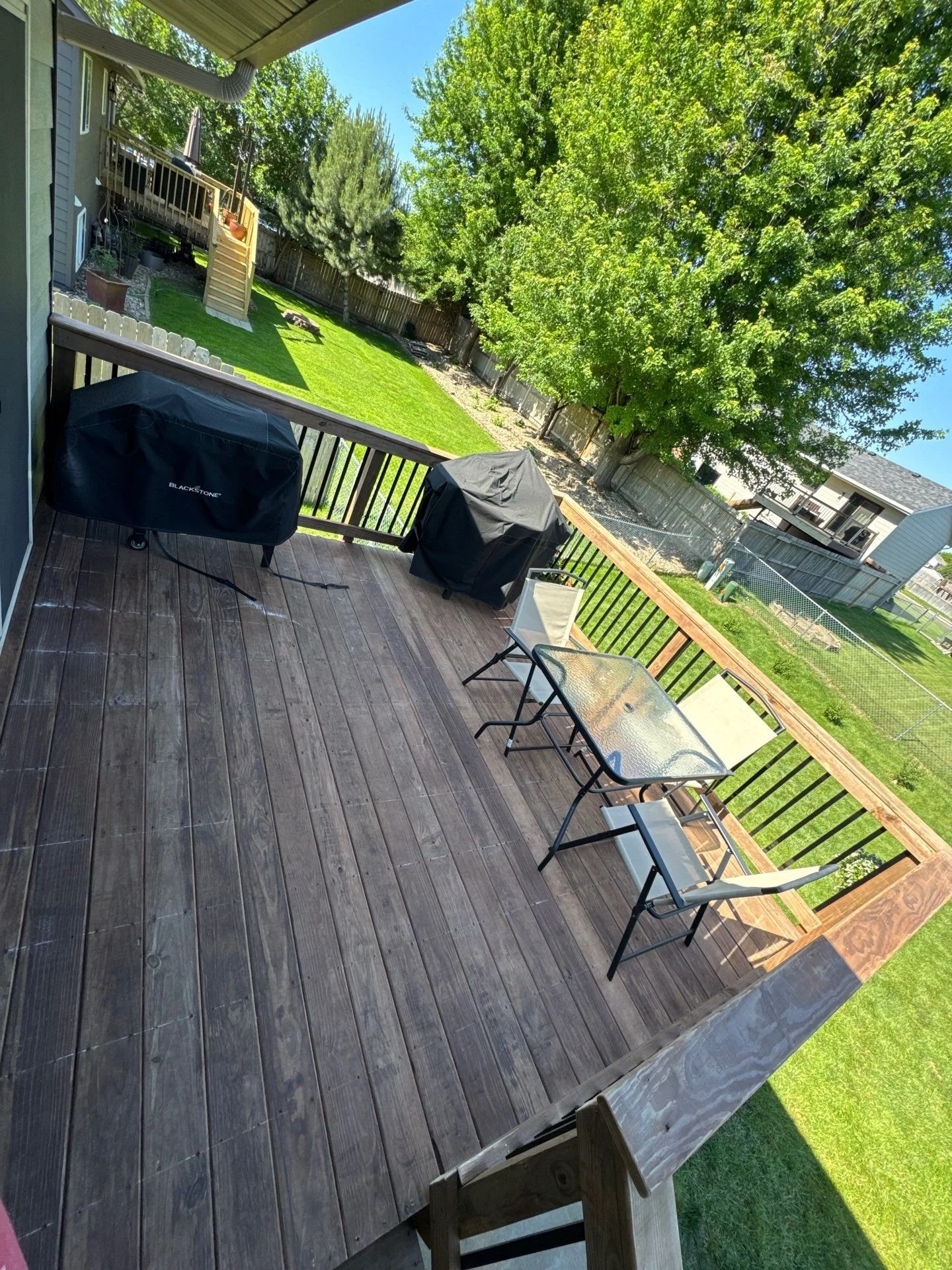 A cedartone deck with default railing