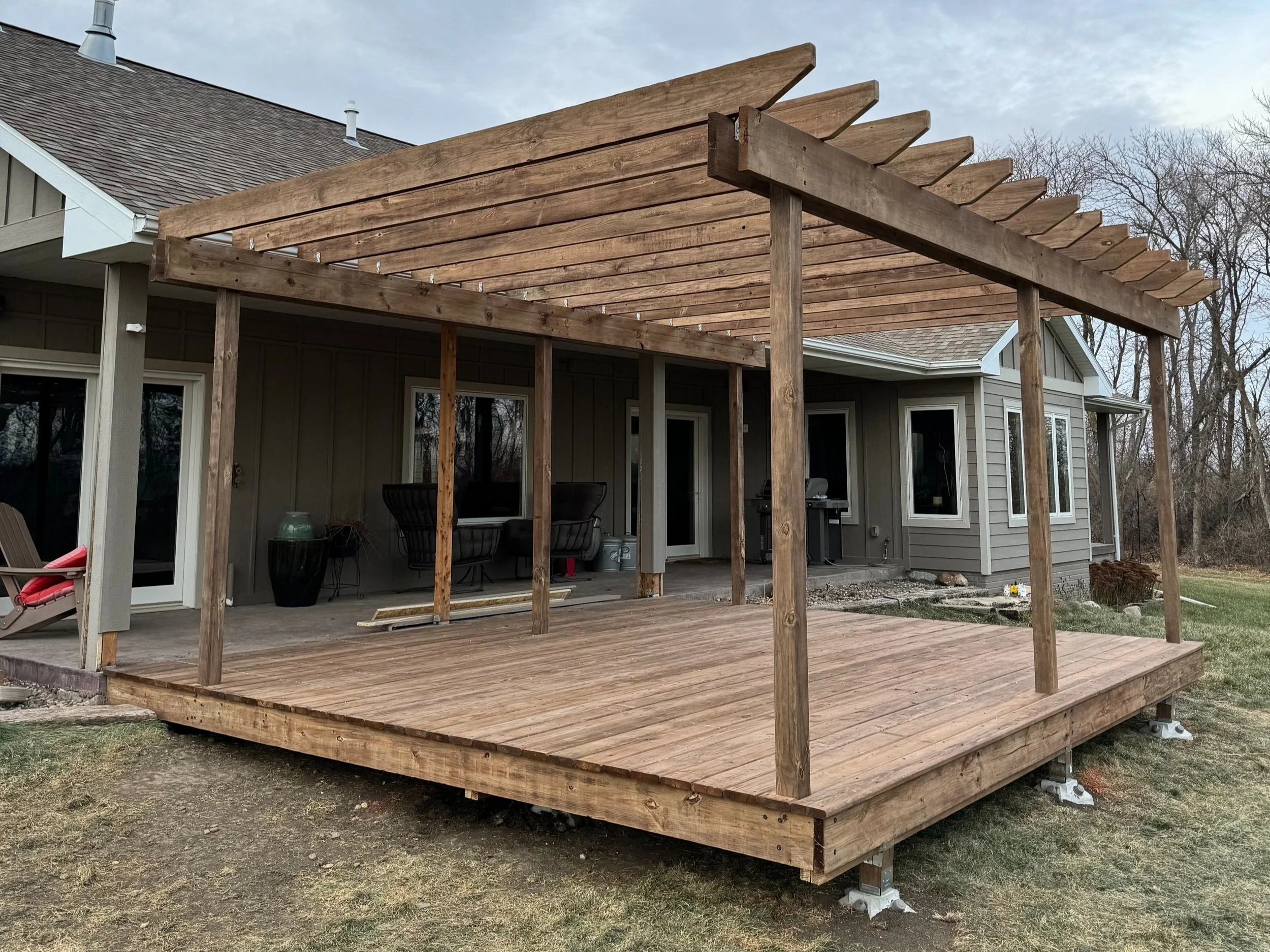 cedartone pressure treated deck boards with default railing and a matching pergola above, no railing