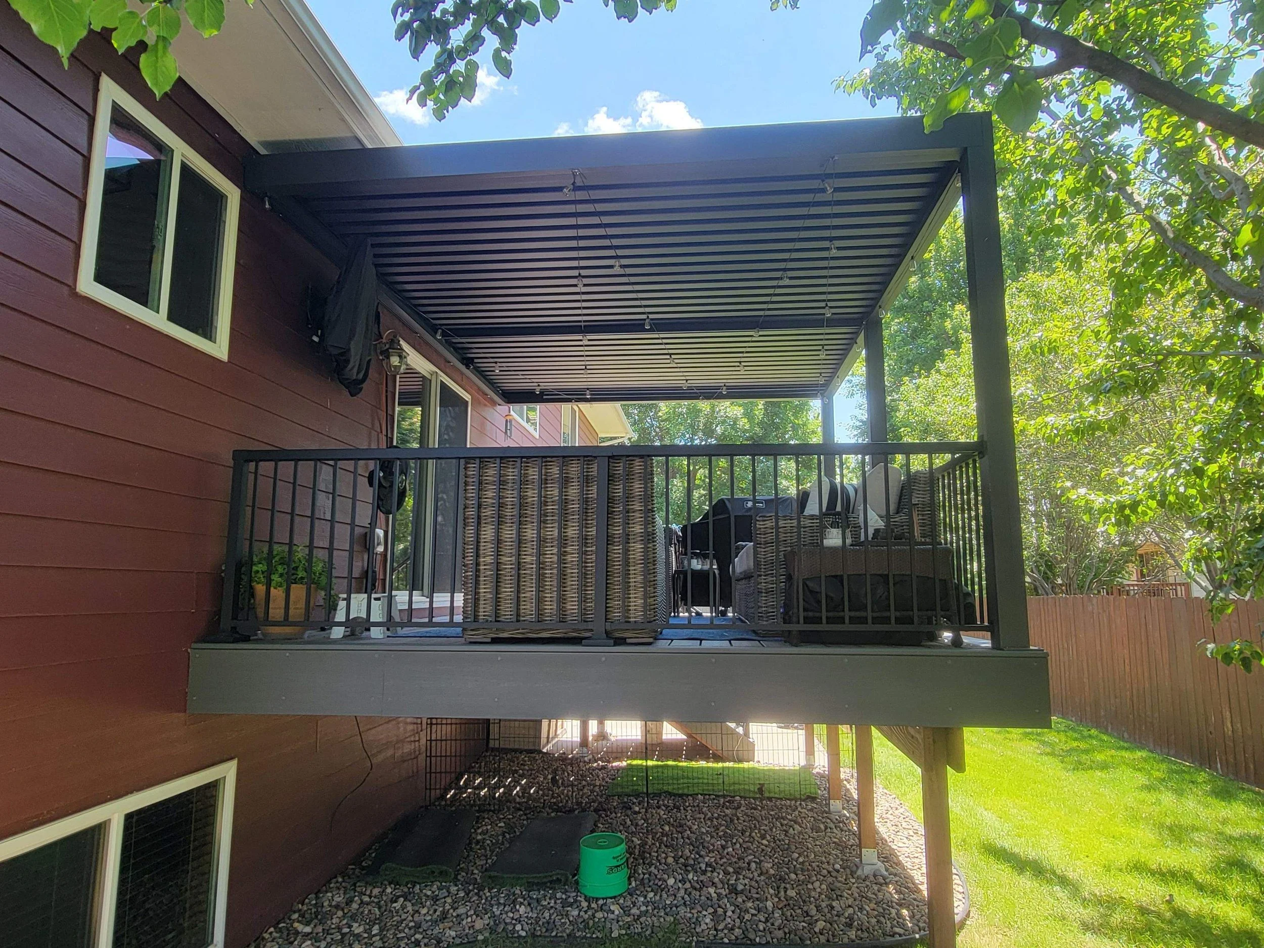 composite deck and metal pergola with motorized louvers