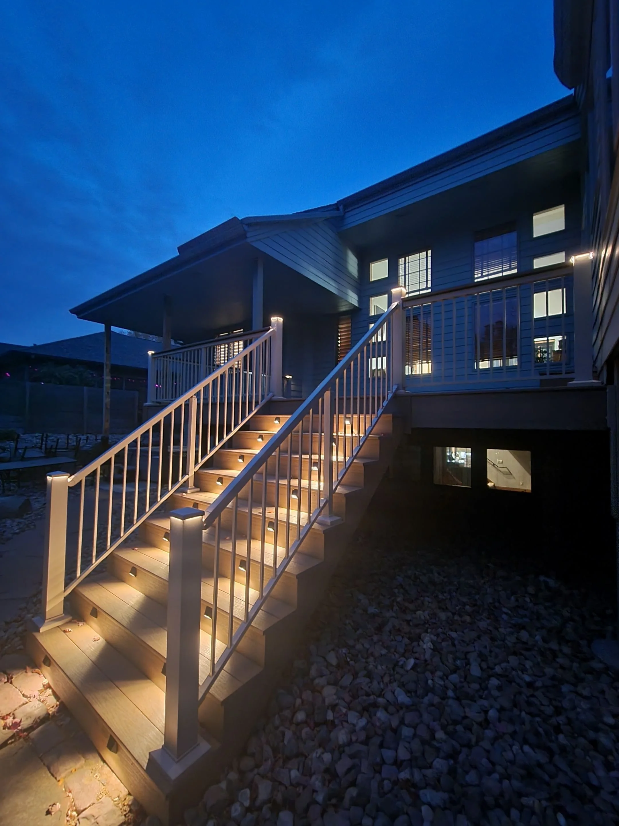 pvc deck boards with beige aluminum railing and integrated lighting