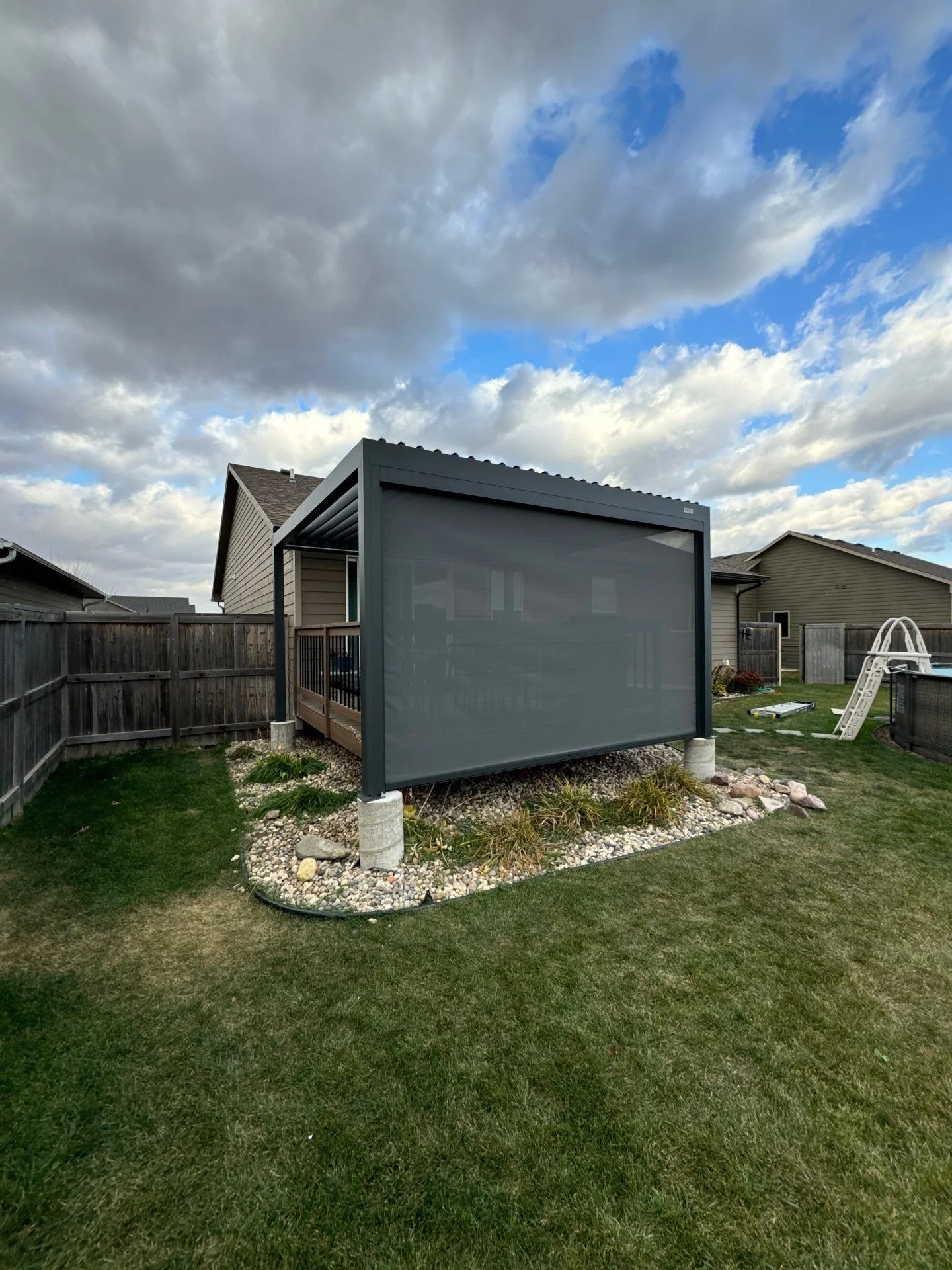 metal pergola with motorized screen and louvers