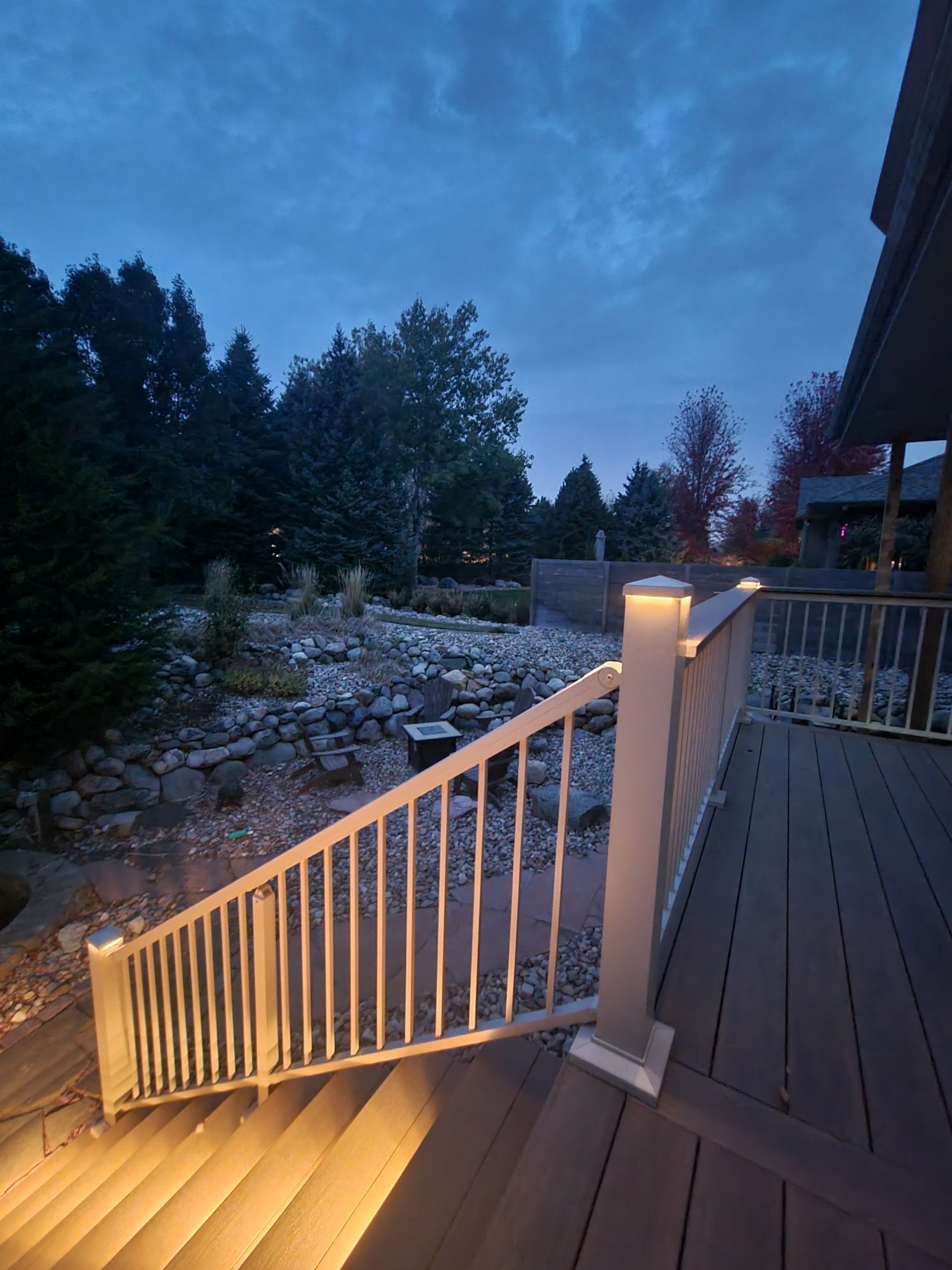 pvc deck stairs with beige aluminum railing and integrated lighting