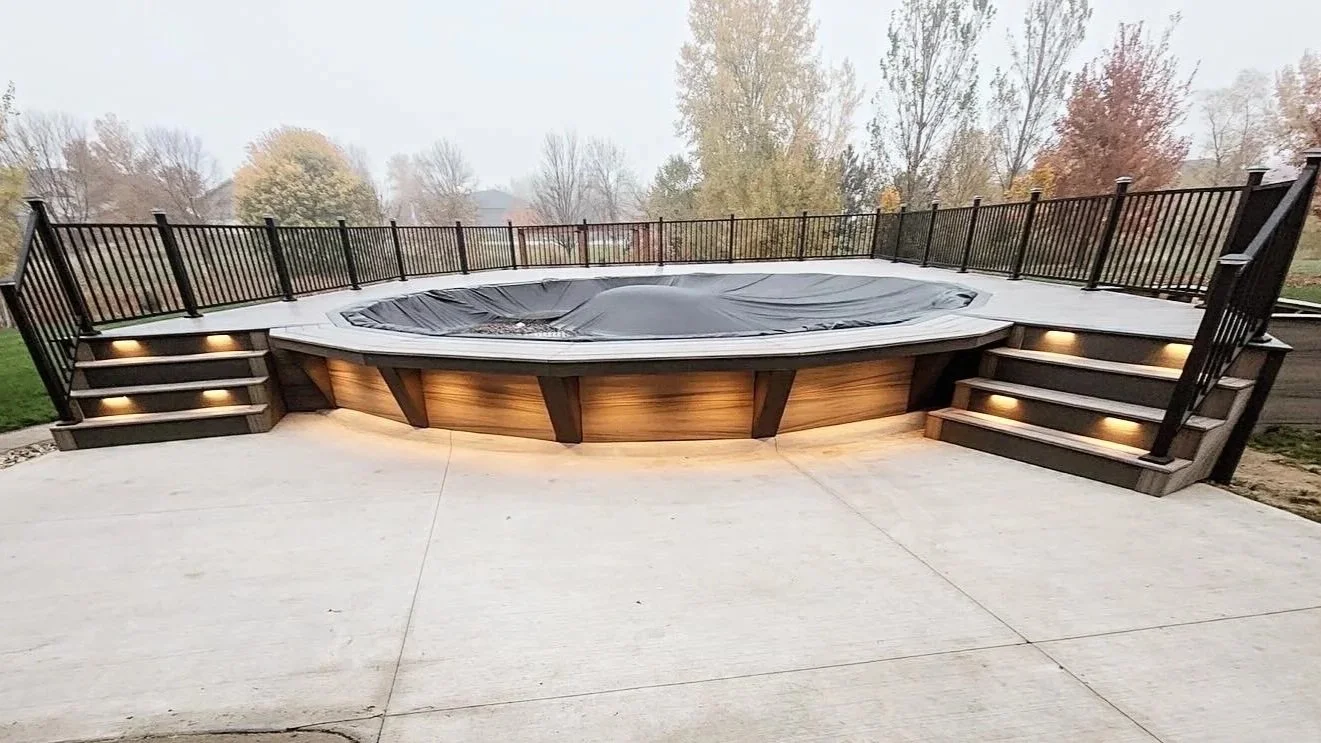 composite pool deck with black aluminum railing and integrated lighting