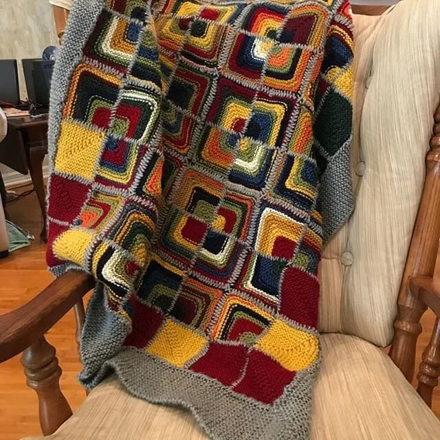 A whole blanket done! This was made with the scraps of a million different projects made into mitered squares with a technique from the Ten Stitch blanket to finish the edges.
It has a delightful weight and was an excellent craft for watching TV.

#k