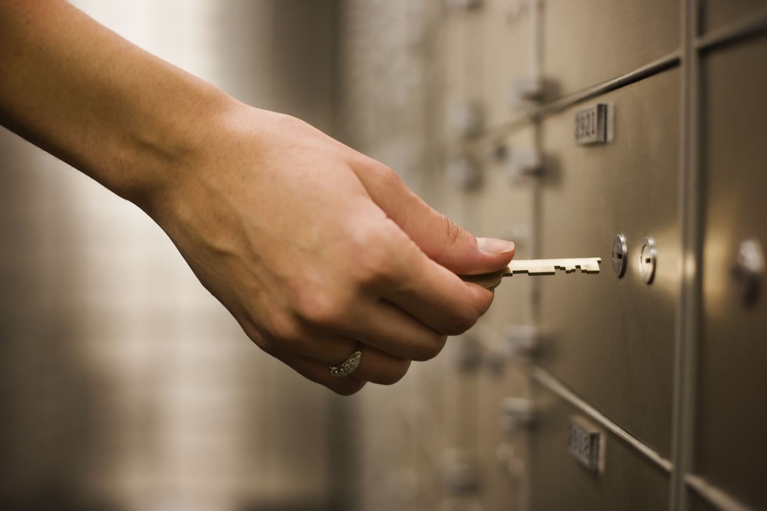 woman-s-hand-holding-key-to-safety-deposit-box-sb10065616j-001-7a2de4c5153b44a9ac9eec562f1fdbcf.jpeg